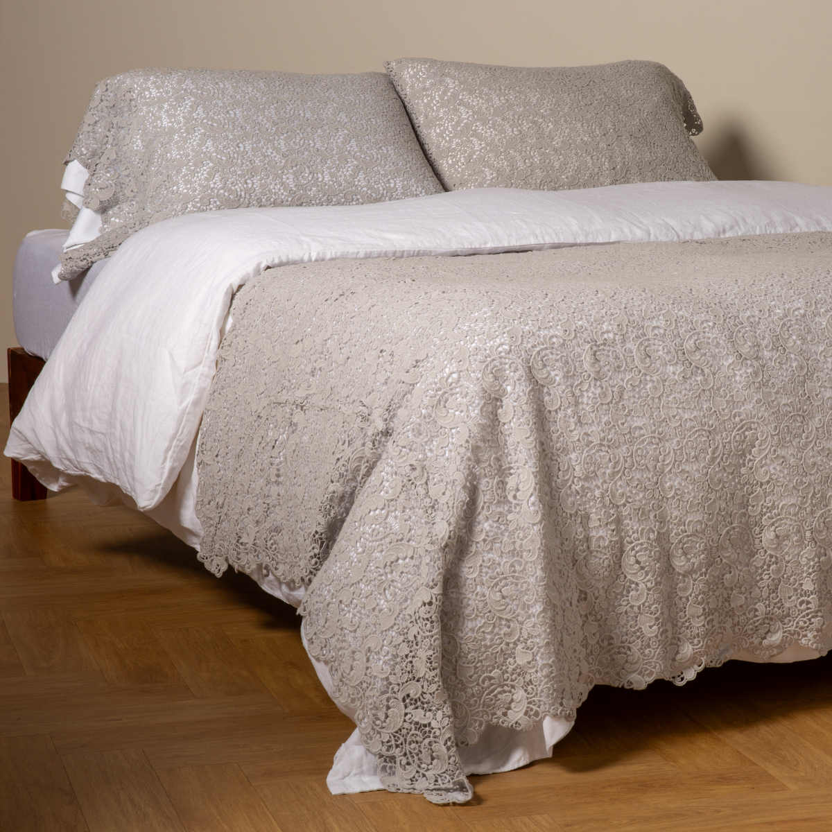 Cloud: cotton lace bed scarf draped across the foot of a bed dressed in linen sheets and duvet cover in winter white - shown with matching lace pillowcase covers over a linen liner in winter white.