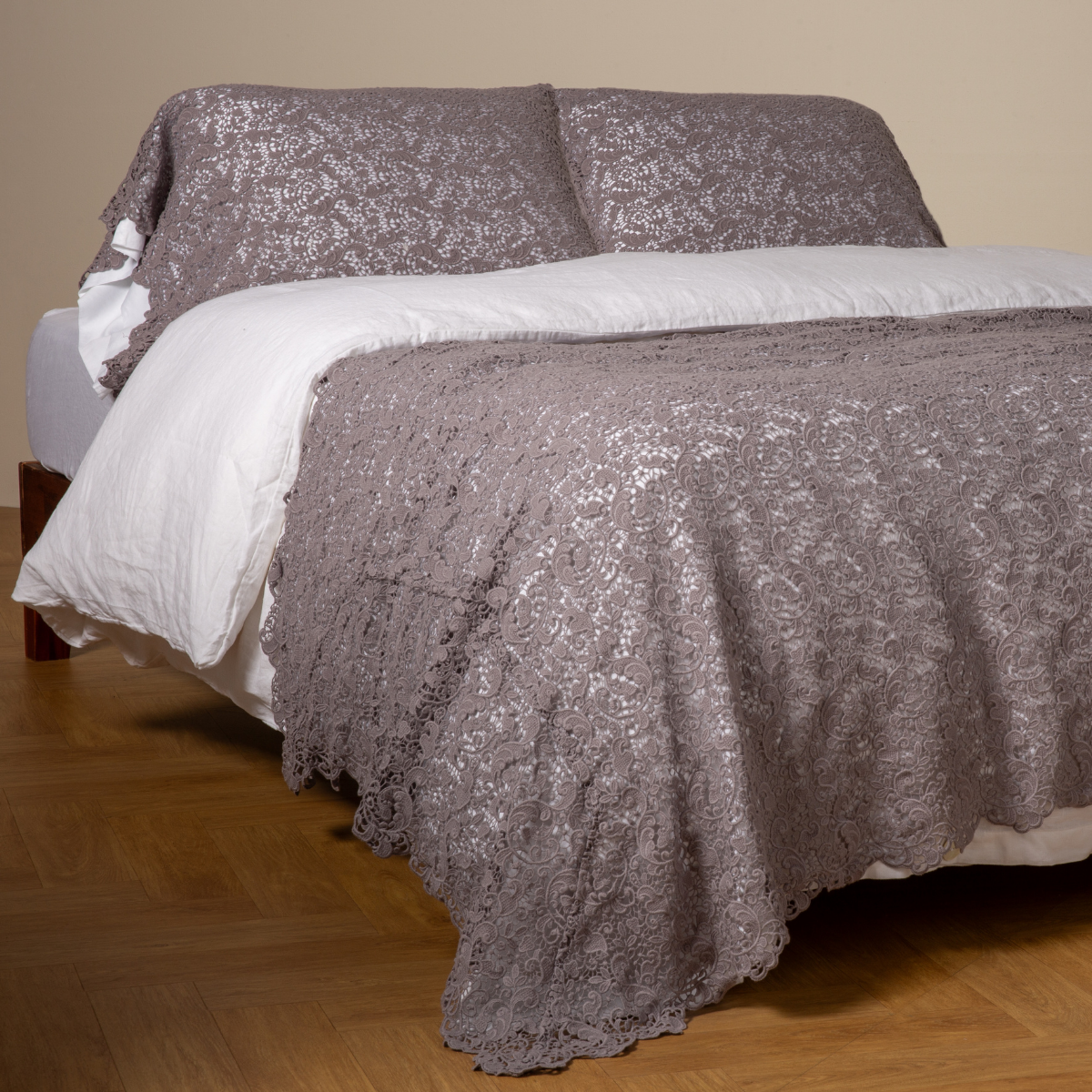 French Lavender: cotton lace bed scarf draped across the foot of a bed dressed in linen sheets and duvet cover in winter white - shown with matching lace pillowcase covers over a linen liner in winter white.