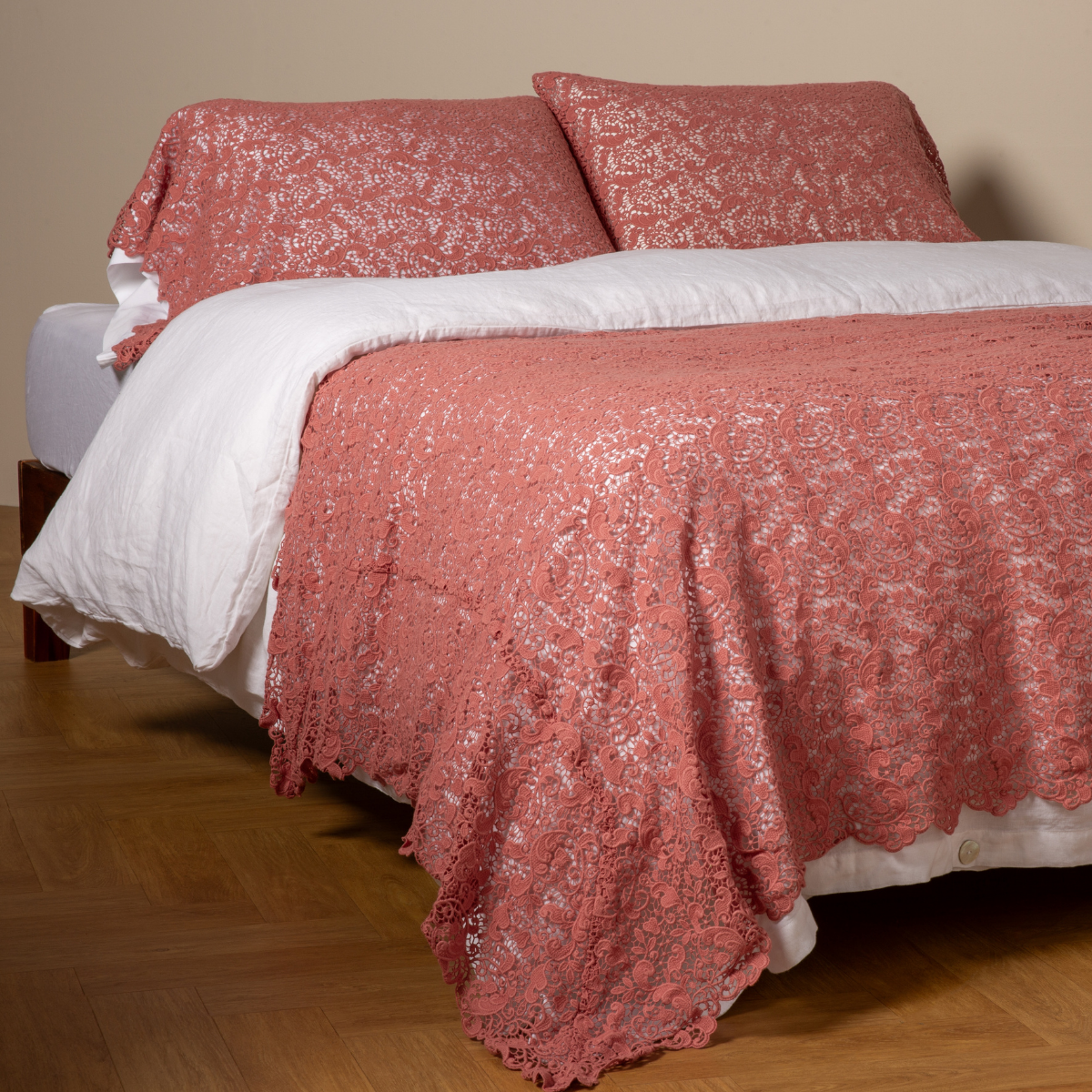Poppy: cotton lace bed scarf draped across the foot of a bed dressed in linen sheets and duvet cover in winter white - shown with matching lace pillowcase covers over a linen liner in winter white.