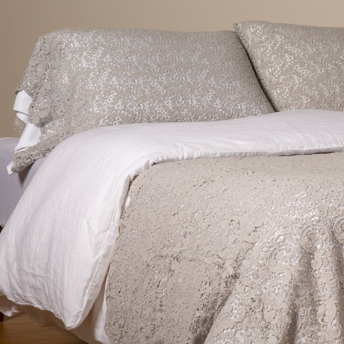 Cloud: a pair of cotton lace pillowcase covers on winter white liners shown on a bed dressed in winter white linen with a matching cotton lace bed scarf.