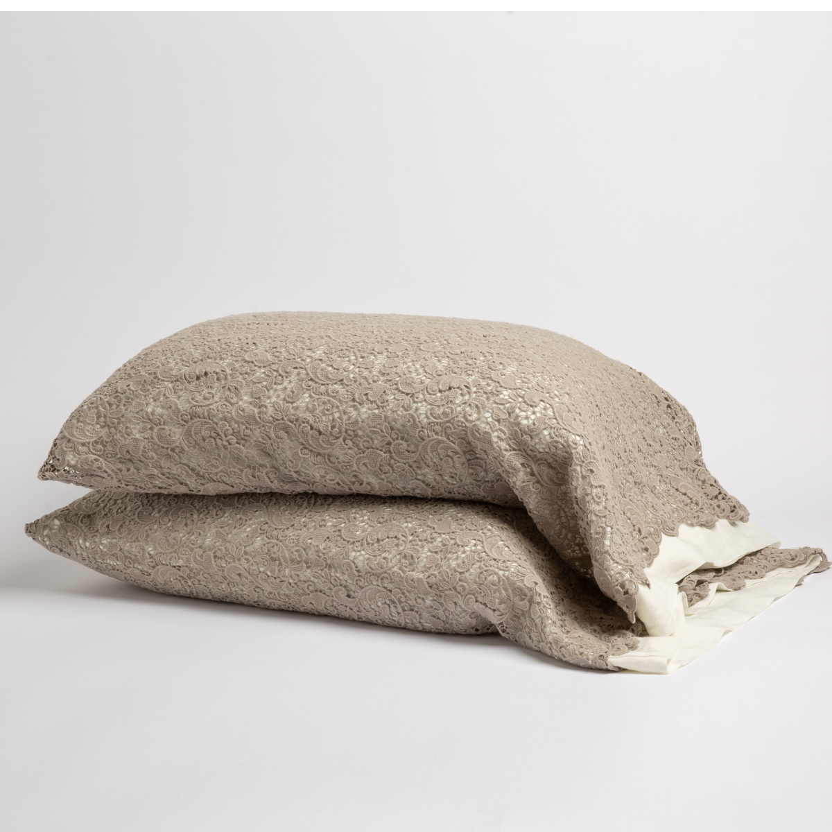 Fog: a pair of stacked cotton lace pillowcase covers on winter white liners against a white background.