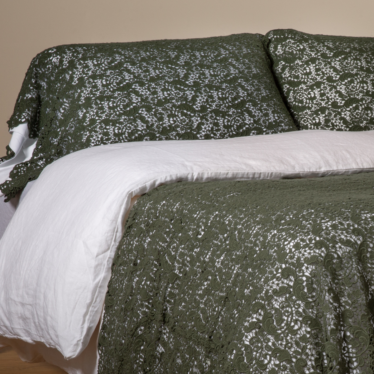 Juniper: a pair of cotton lace pillowcase covers on winter white liners shown on a bed dressed in winter white linen with a matching cotton lace bed scarf.