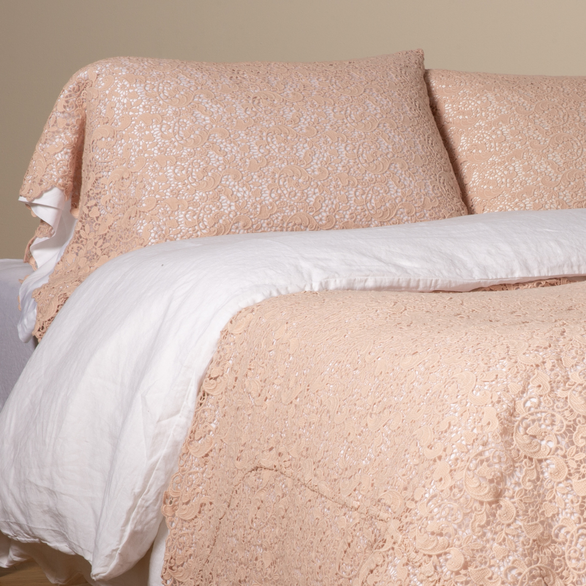 Pearl: a pair of cotton lace pillowcase covers on winter white liners shown on a bed dressed in winter white linen with a matching cotton lace bed scarf.