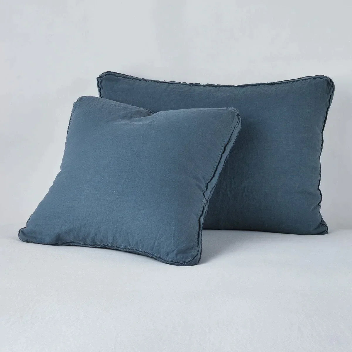 Midnight: Midweight linen shams in midnight colorway shown leaning upright on white background.