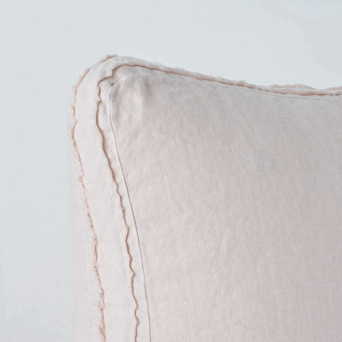 Pearl: Close-up angle of the corner of an Austin sham, highlighting the raw edge trim on either side of the gusset.