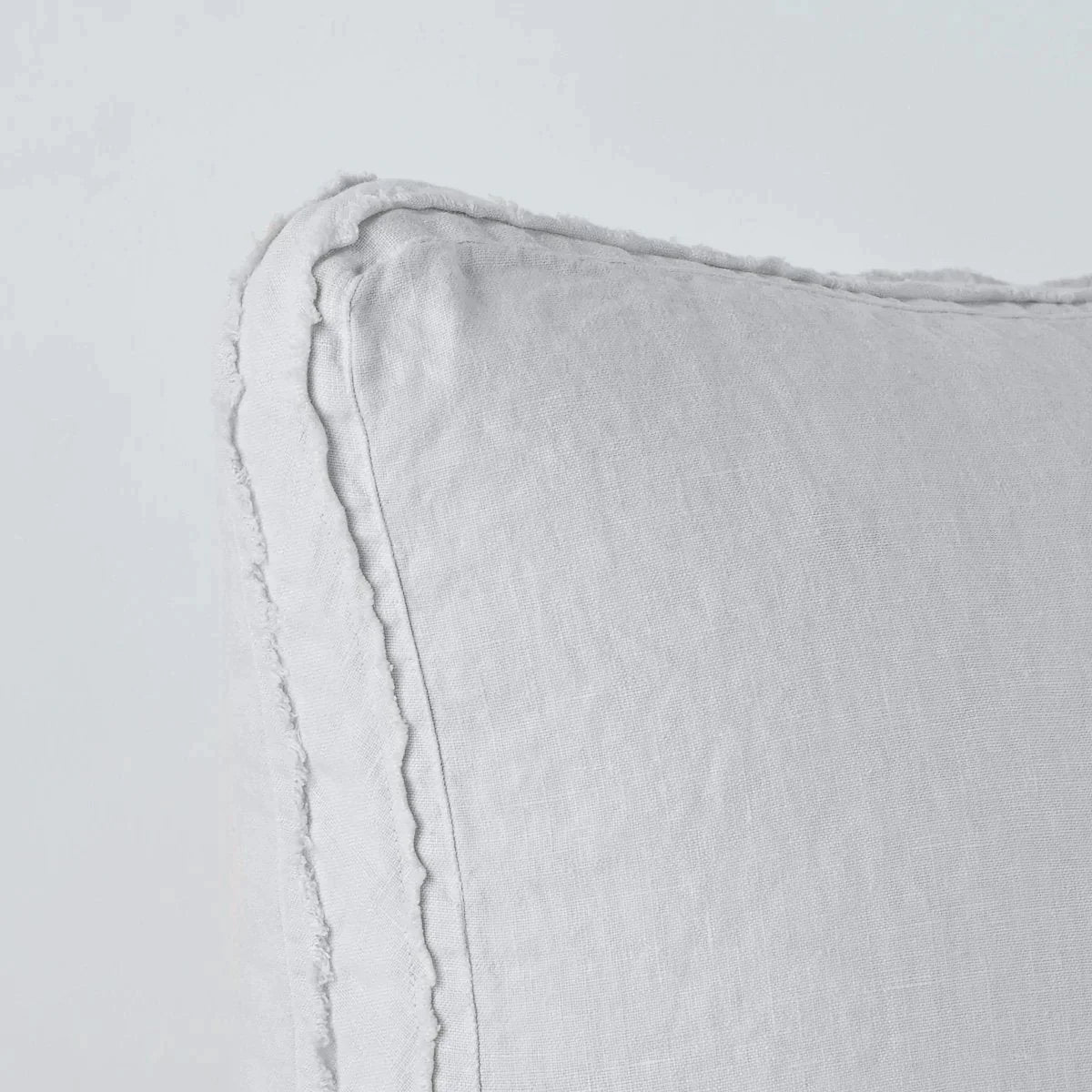 Sterling: Close-up angle of the corner of an Austin sham, highlighting the raw edge trim on either side of the gusset.