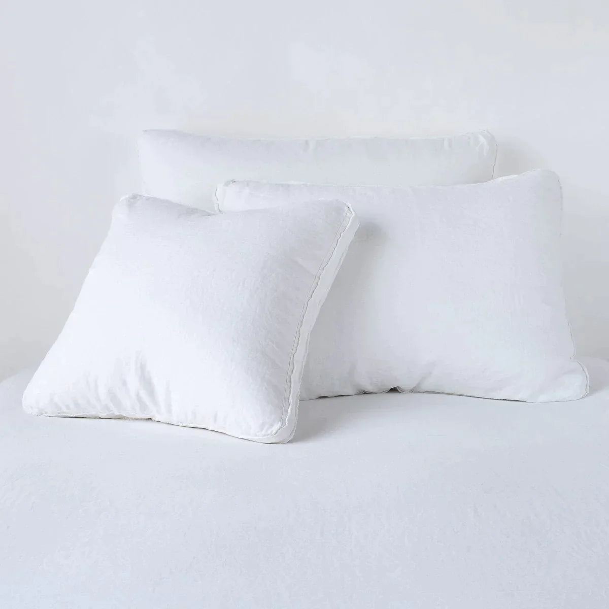 White: Midweight linen shams in white colorway shown leaning upright on white background.