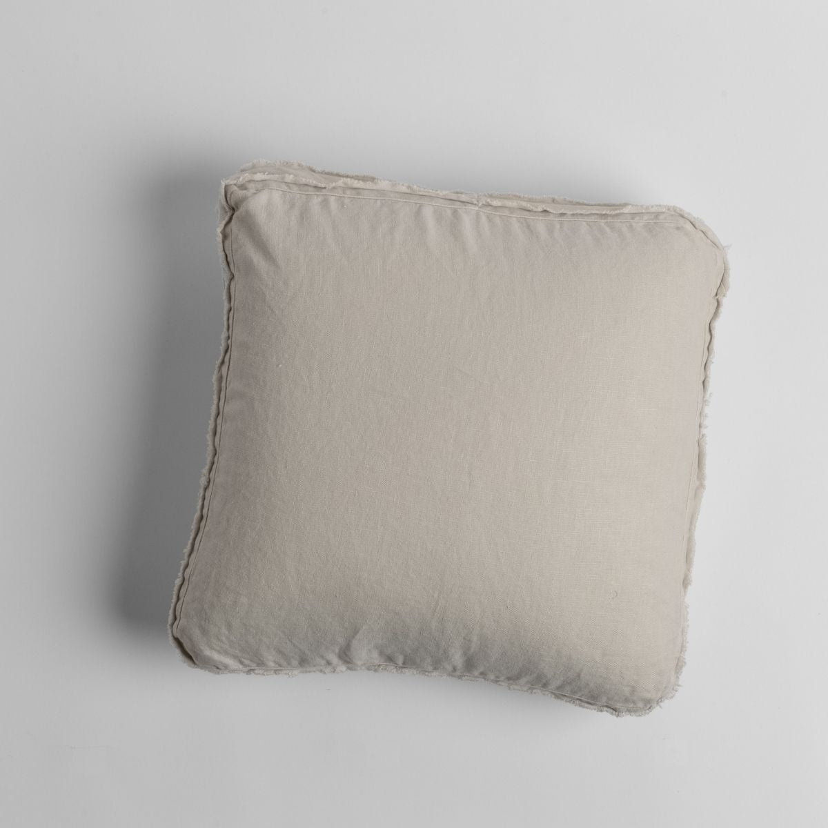 Parchment: midweight linen 18x18 inch throw pillow shot from overhead against a white background.