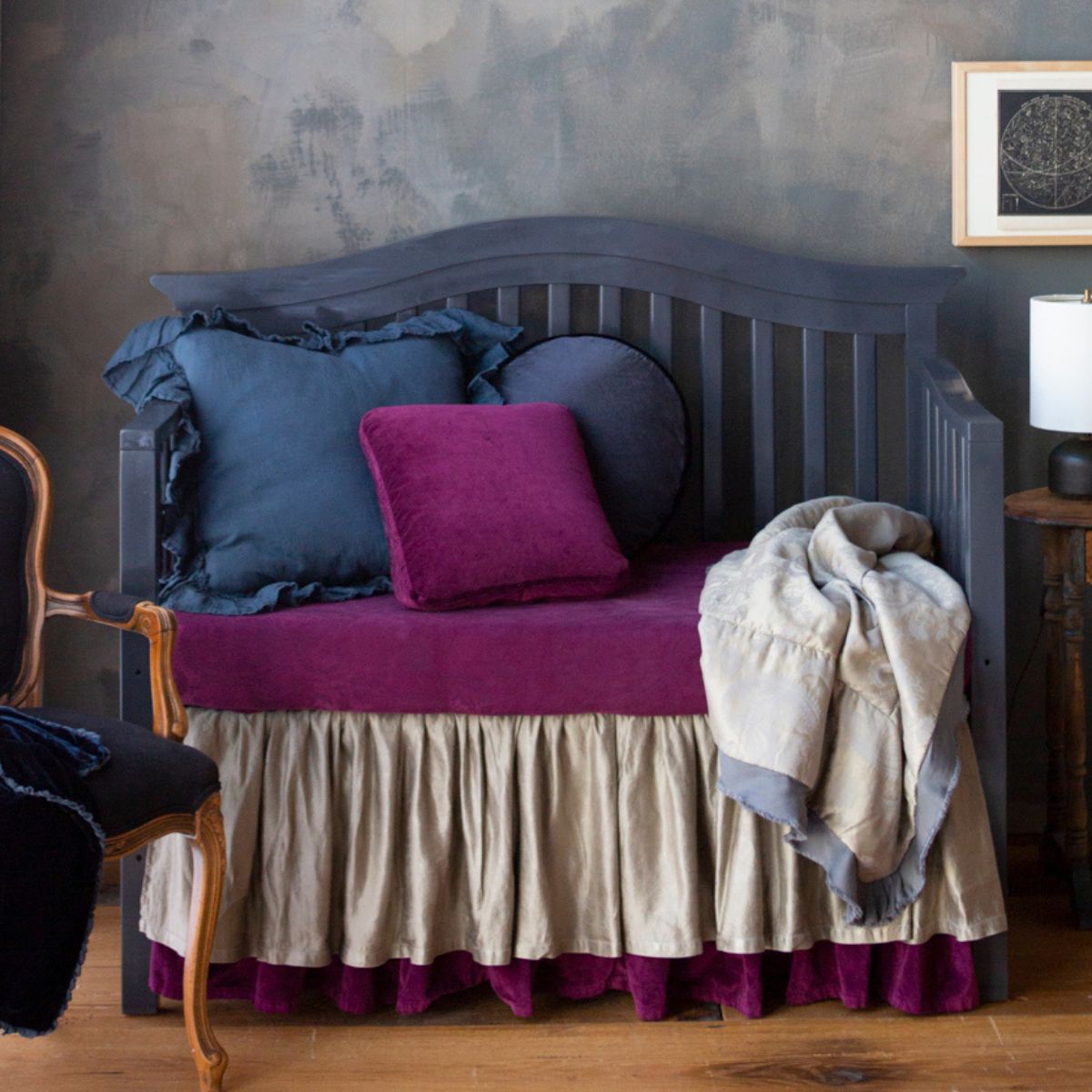 : a moody crib scene with jewel toned crib bedding and touches of greys.
