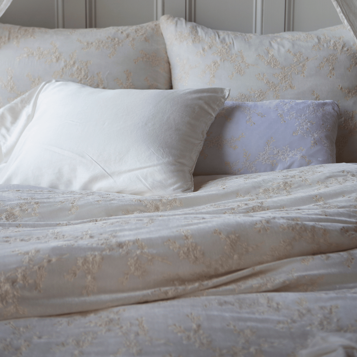 Winter White: a pair of deluxe shams with matching duvet cover shown with a pillowcase from the seraphina collection and 15x24 lynette pillow in white.