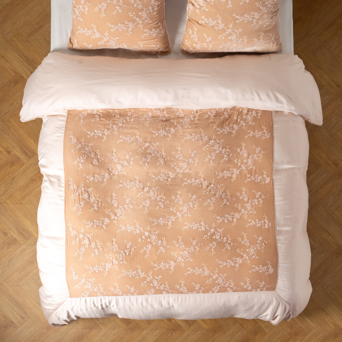 Pearl: An overhead shot of an embroidered silk velvet and tencel duvet cover and matching shams.