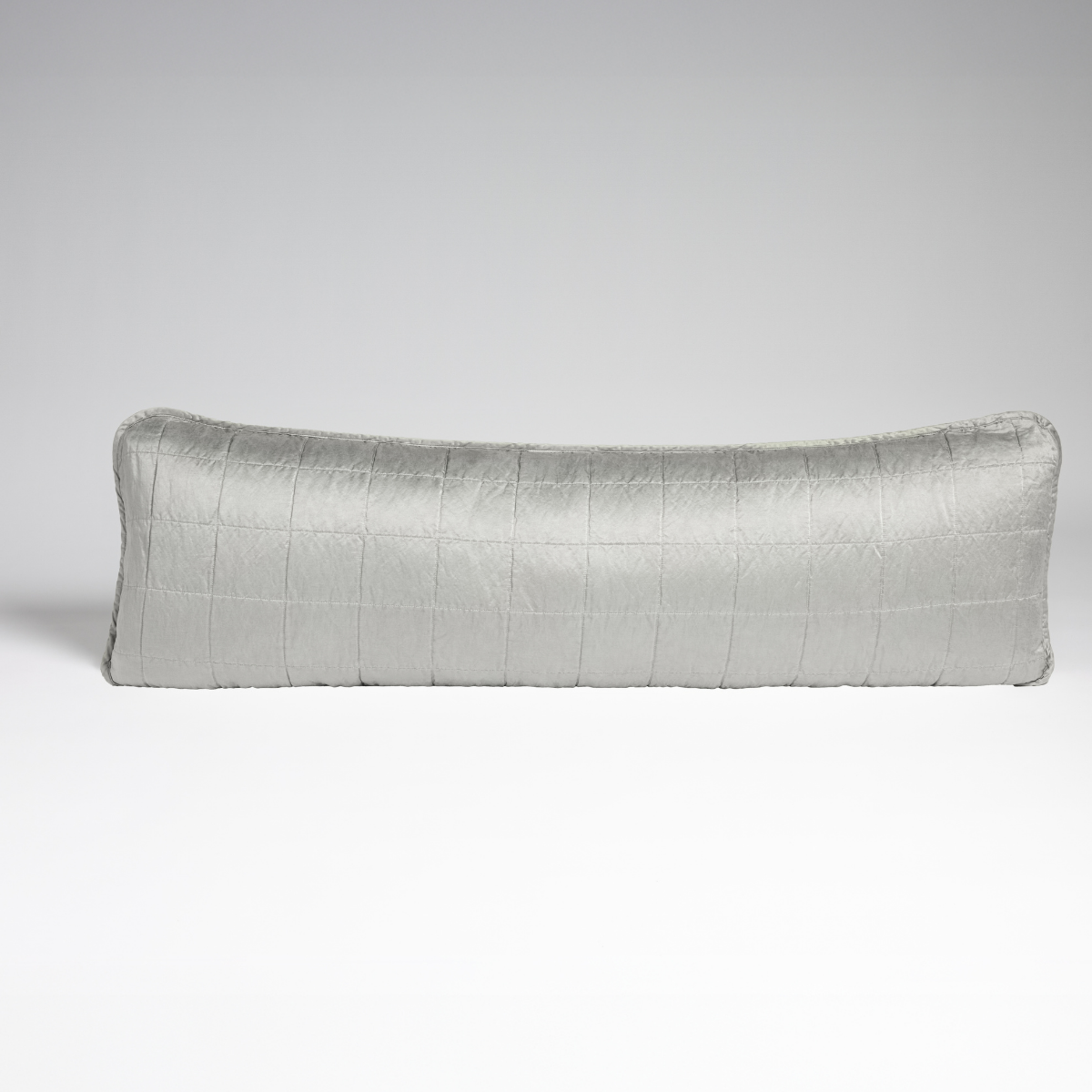 Cloud: A straight-on shot of a square-quilted body pillow in cloud, a subtle sky blue-grey, against a white background.