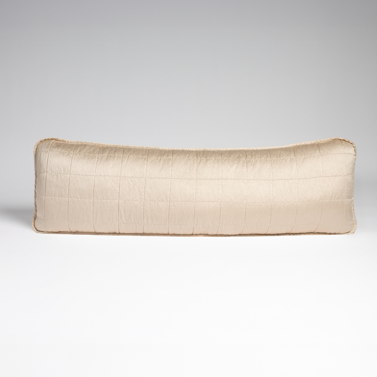 Pearl: A straight-on shot of a square-quilted body pillow in pearl, a soft rose pink tone, against a white background.