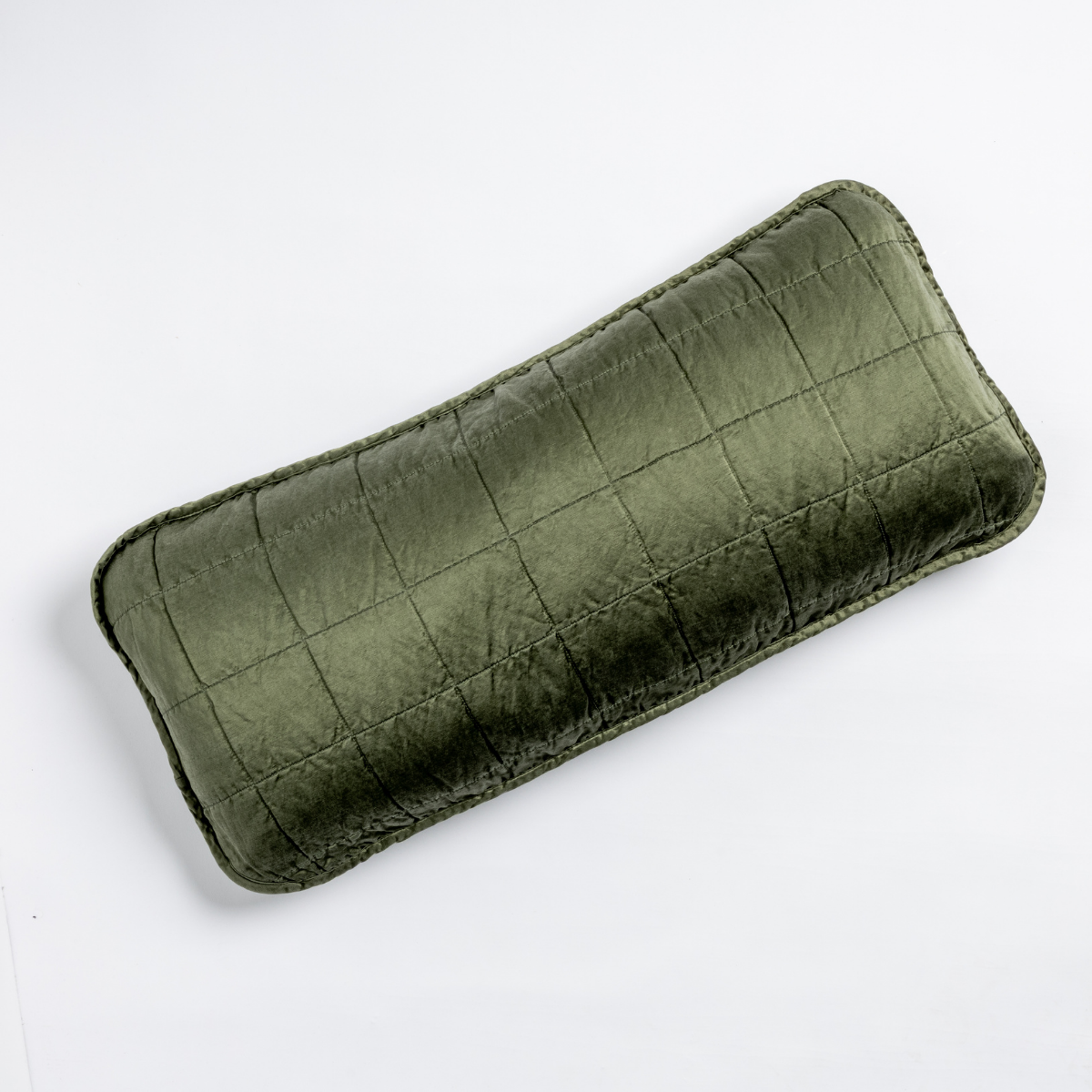 Juniper: An overhead shot of a square-quilted rectangle throw pillow in juniper, a deeply saturated dark green, against a white background.
