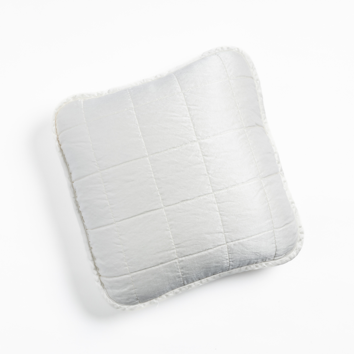 White: An overhead shot of a square-quilted square throw pillow in white, against a white background.