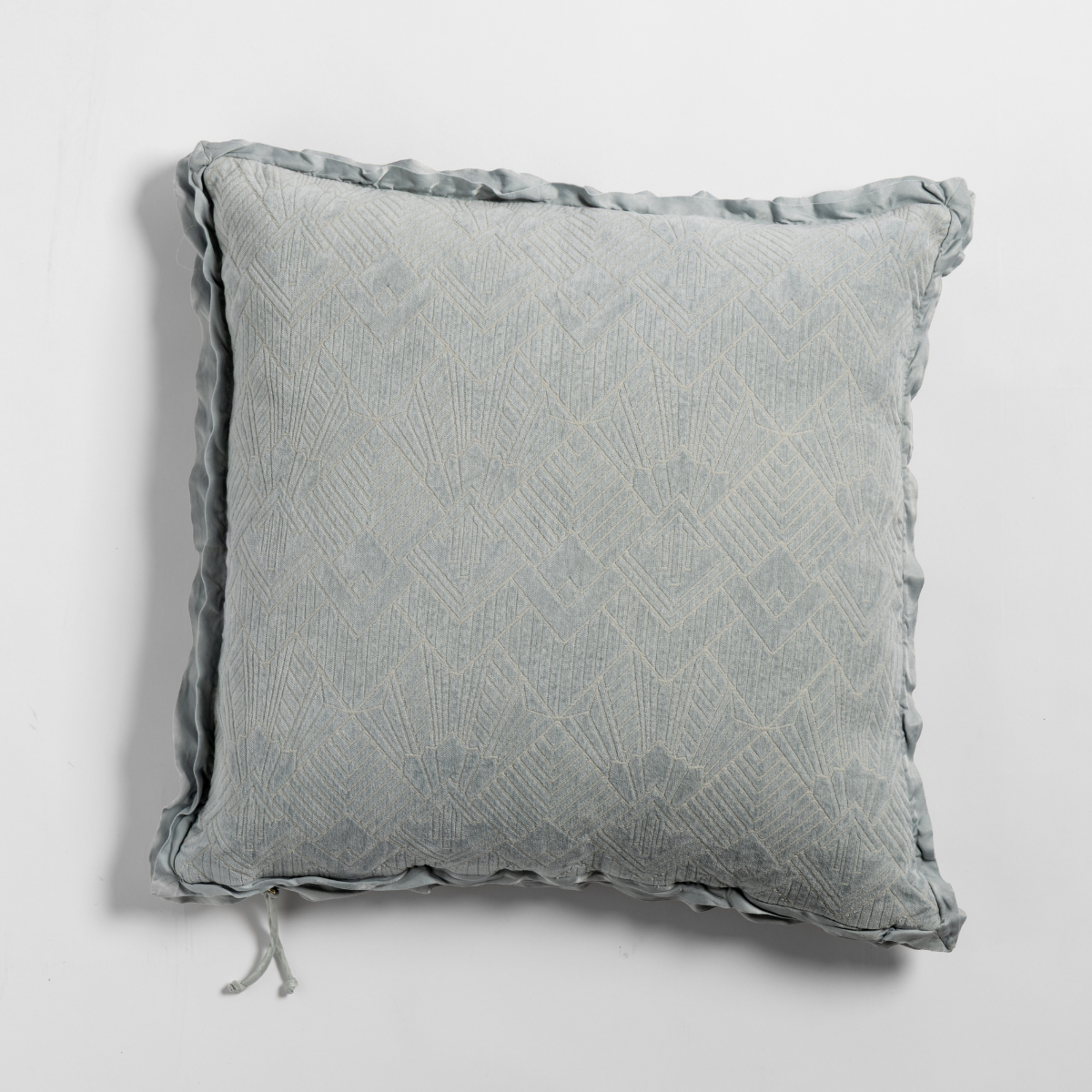 Cloud: The chenille side of a textured throw pillow with contrasting ruffled edges, shot from overhead against a plain background.