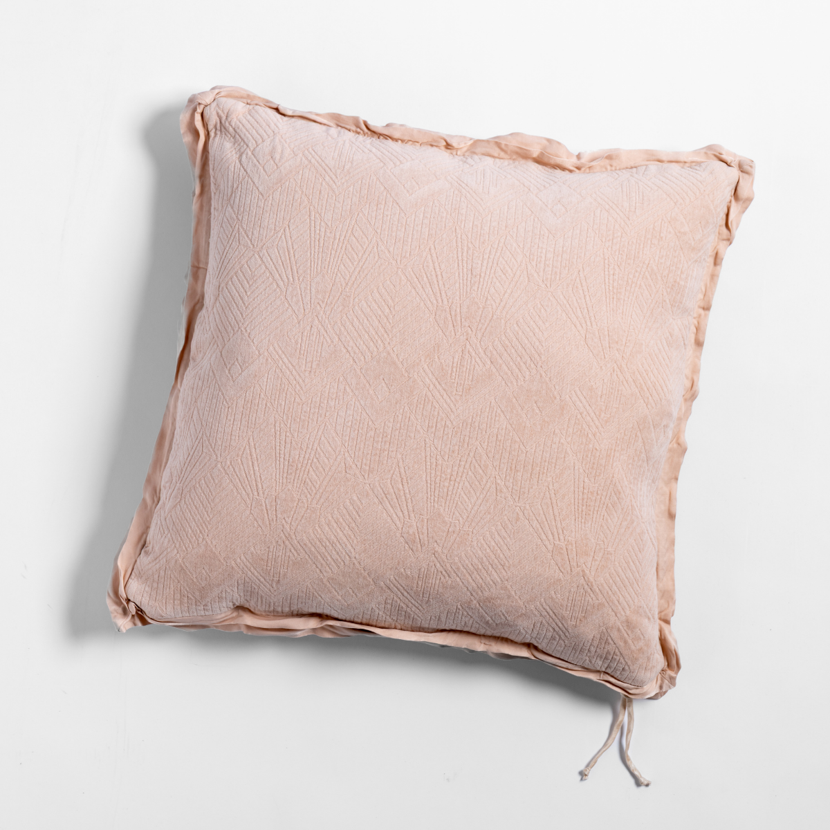 Pearl: The chenille side of a textured throw pillow with contrasting ruffled edges, shot from overhead against a plain background.