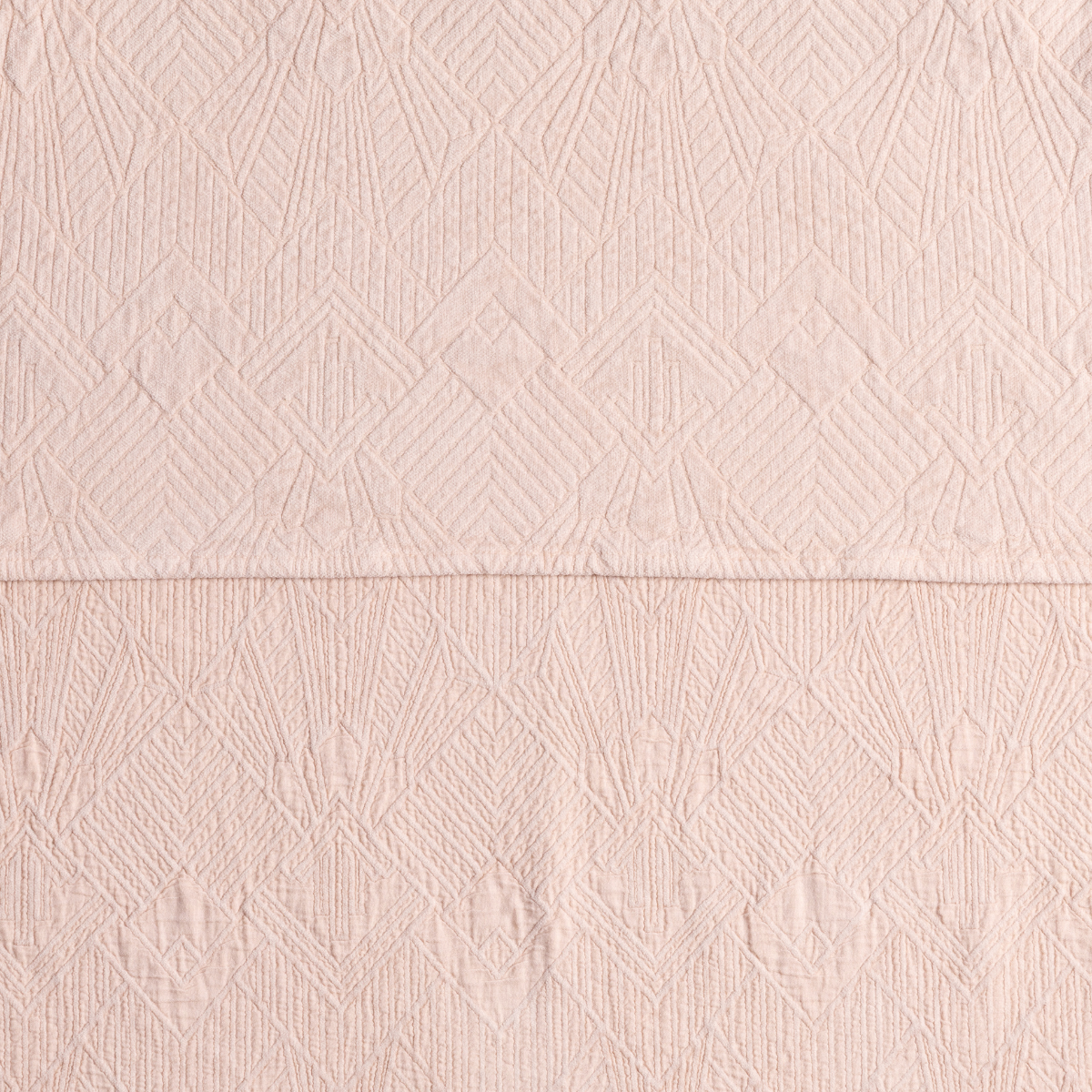 Pearl: a close-up showing the chenille jacquard on the top half and cotton jacquard on the bottom in pearl, a pale pink tone.