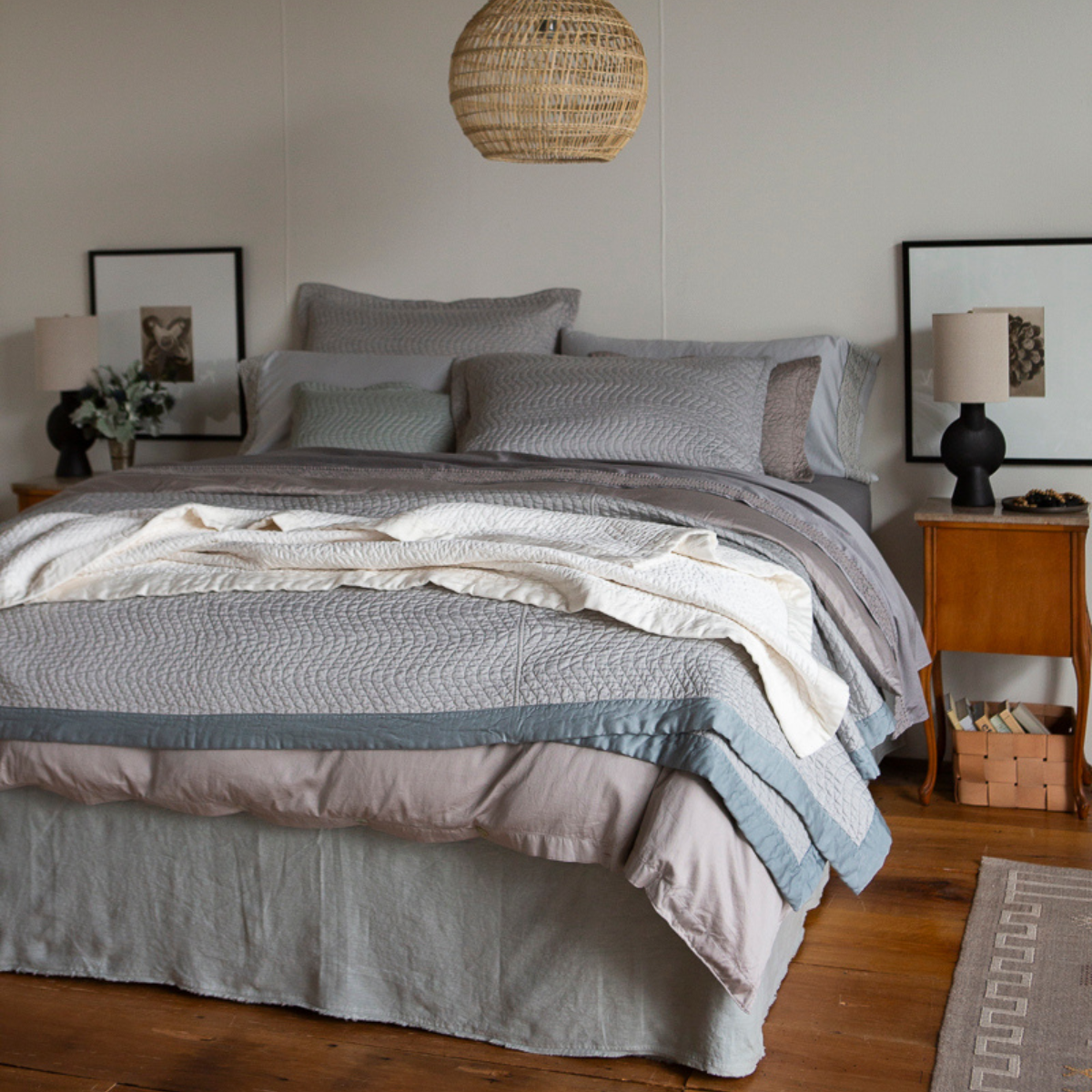 : king sized bed dressed in cotton sateen, quilted and unquilted - cool and neutral tones on the bed with warm room accents.