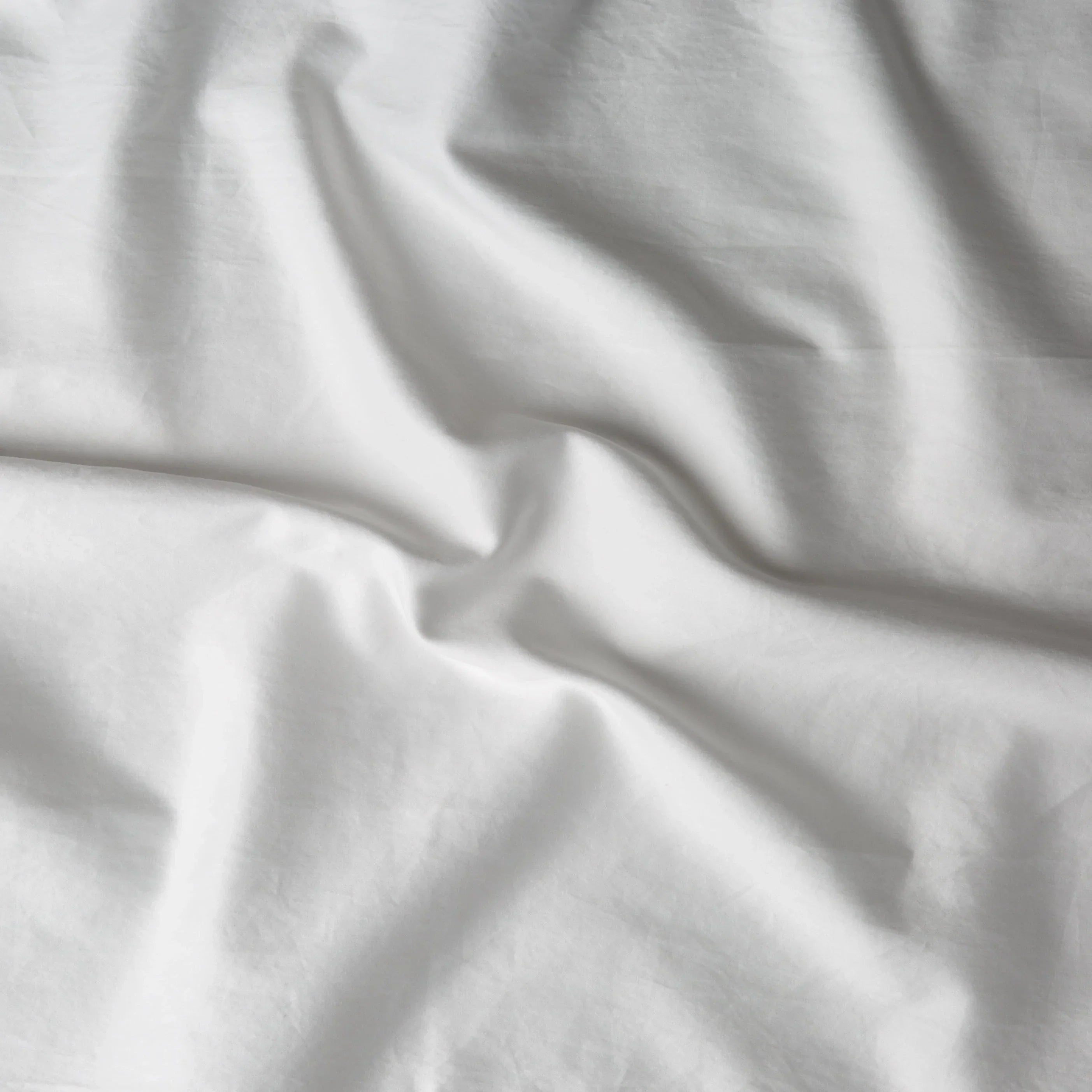 Winter White: A close up of cotton sateen fabric in winter white, softer and warmer in tone than classic white.