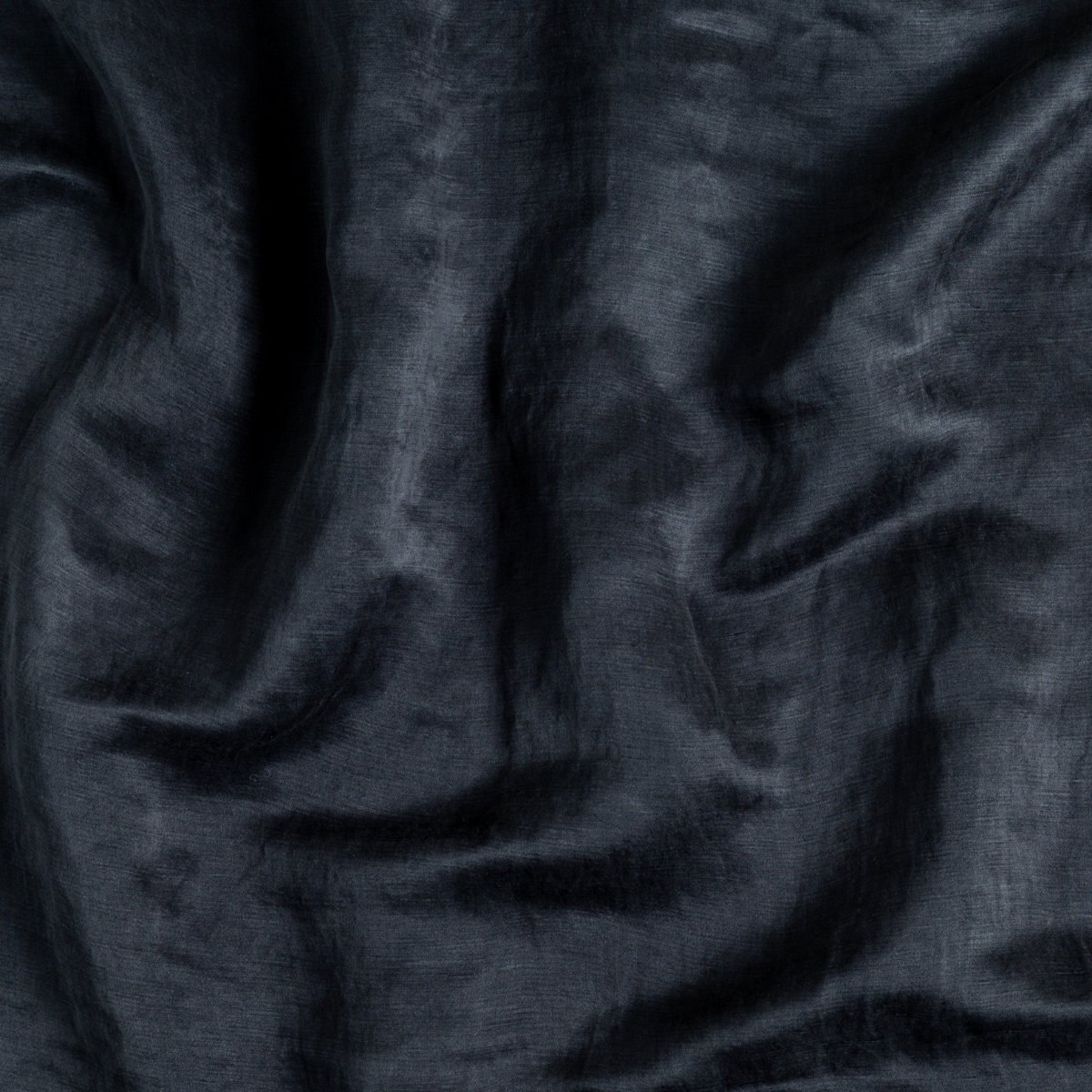 Midnight: A close up of charmeuse fabric in midnight, a rich indigo tone.