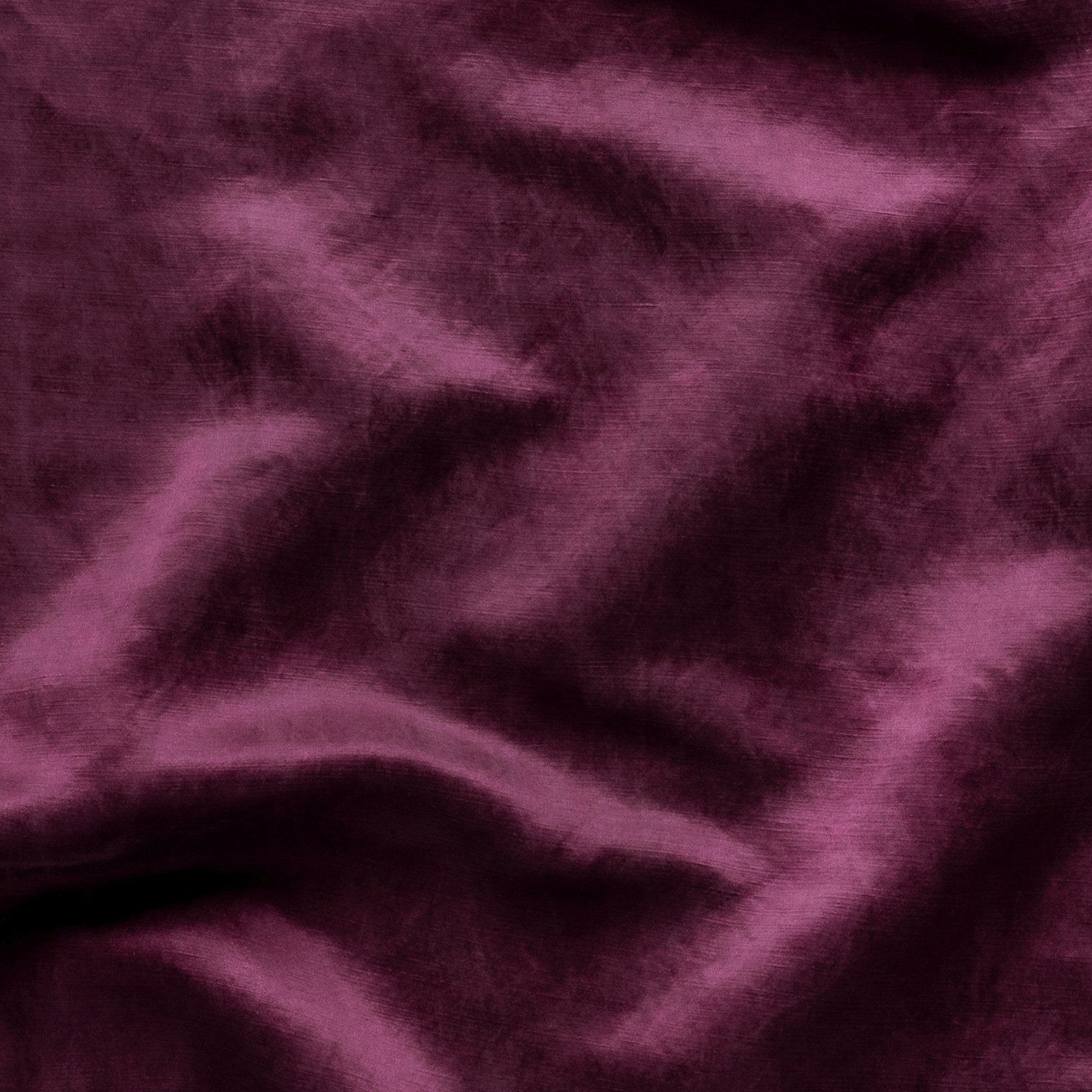 Fig: Close-up of silk charmeuse in fig, a richly saturated purple-garnet.
