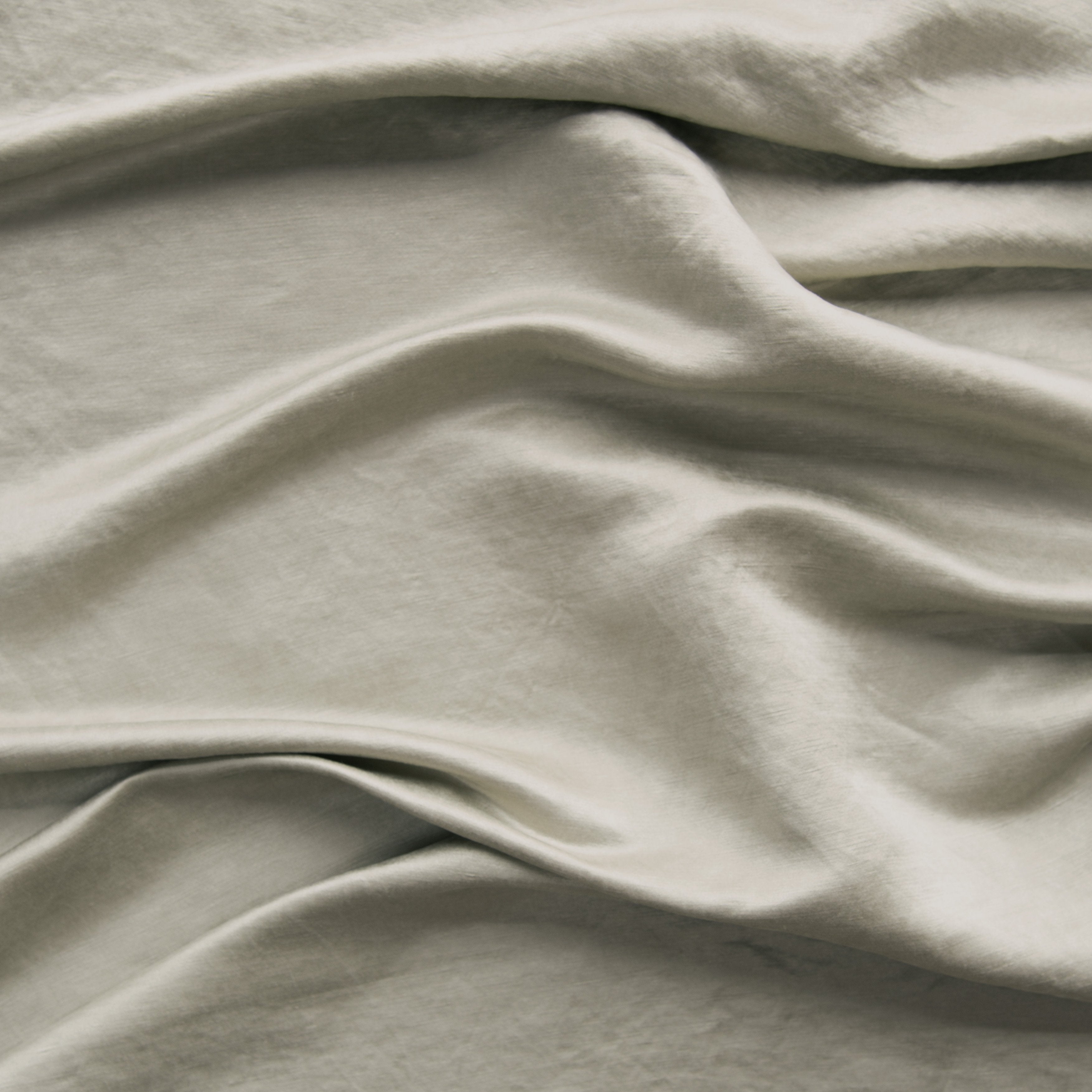 Fog: Close-up of silk charmeuse in fog, a neutral-warm, soft mid-tone grey.