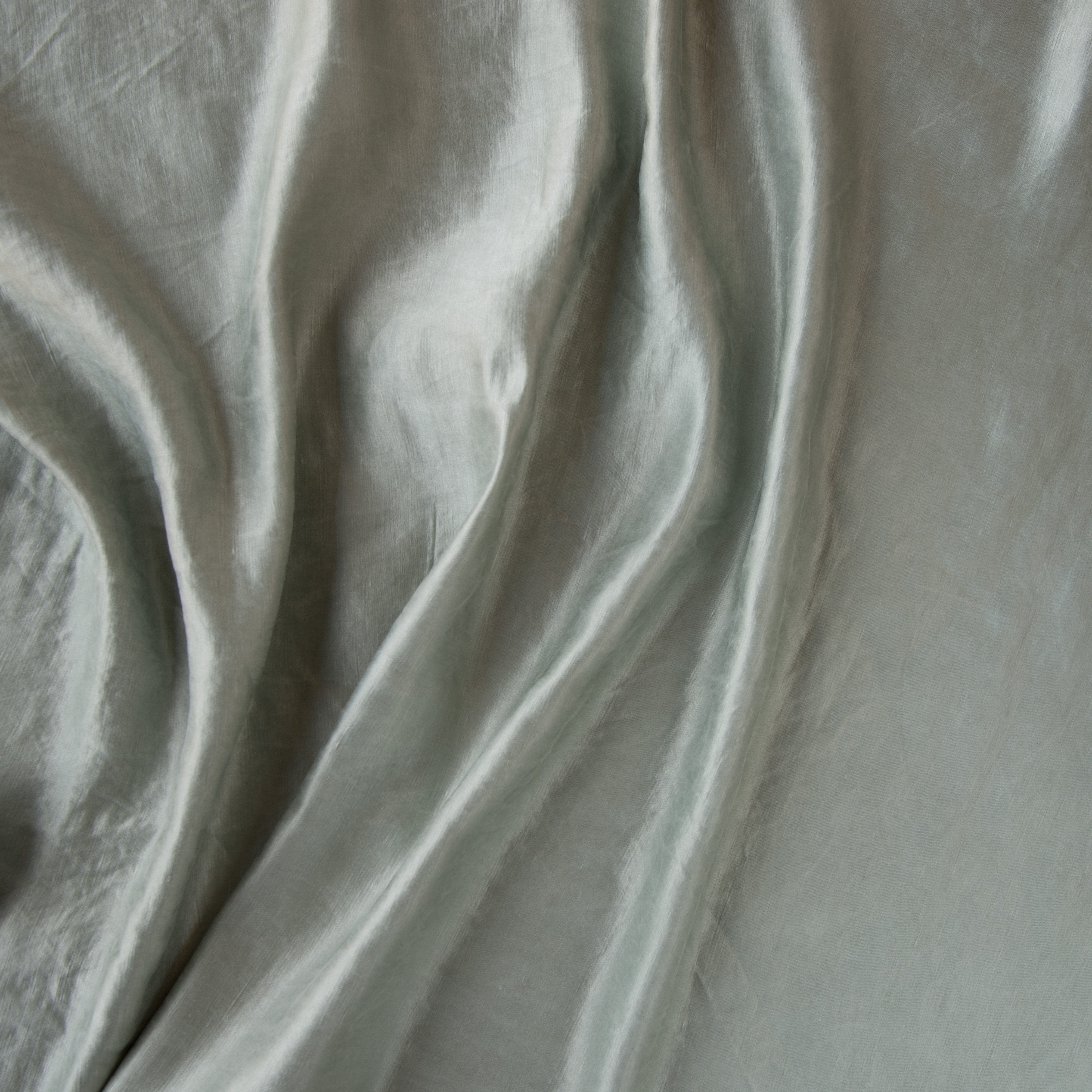 Mineral: Close-up of silk charmeuse in mineral, a soothing seafoam blue with subtle grey-green undertones.