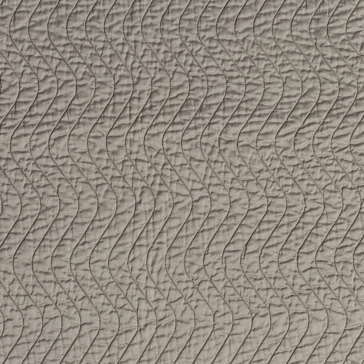 Fog: A close up of quilted cotton sateen fabric in fog, a neutral-warm, soft mid-tone grey.