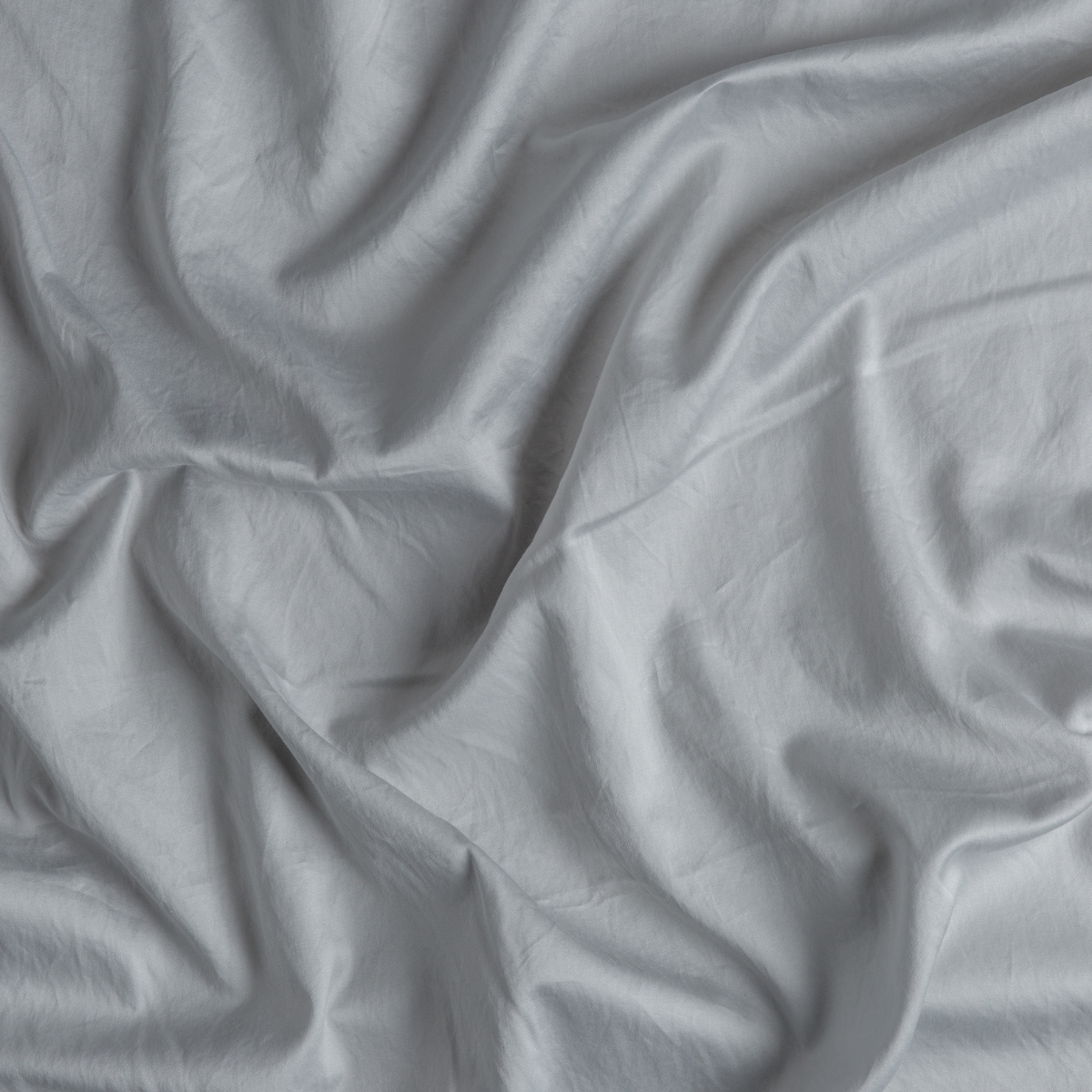 Cloud: A close up of cotton sateen fabric in cloud, a soft, subtle sky blue-grey.