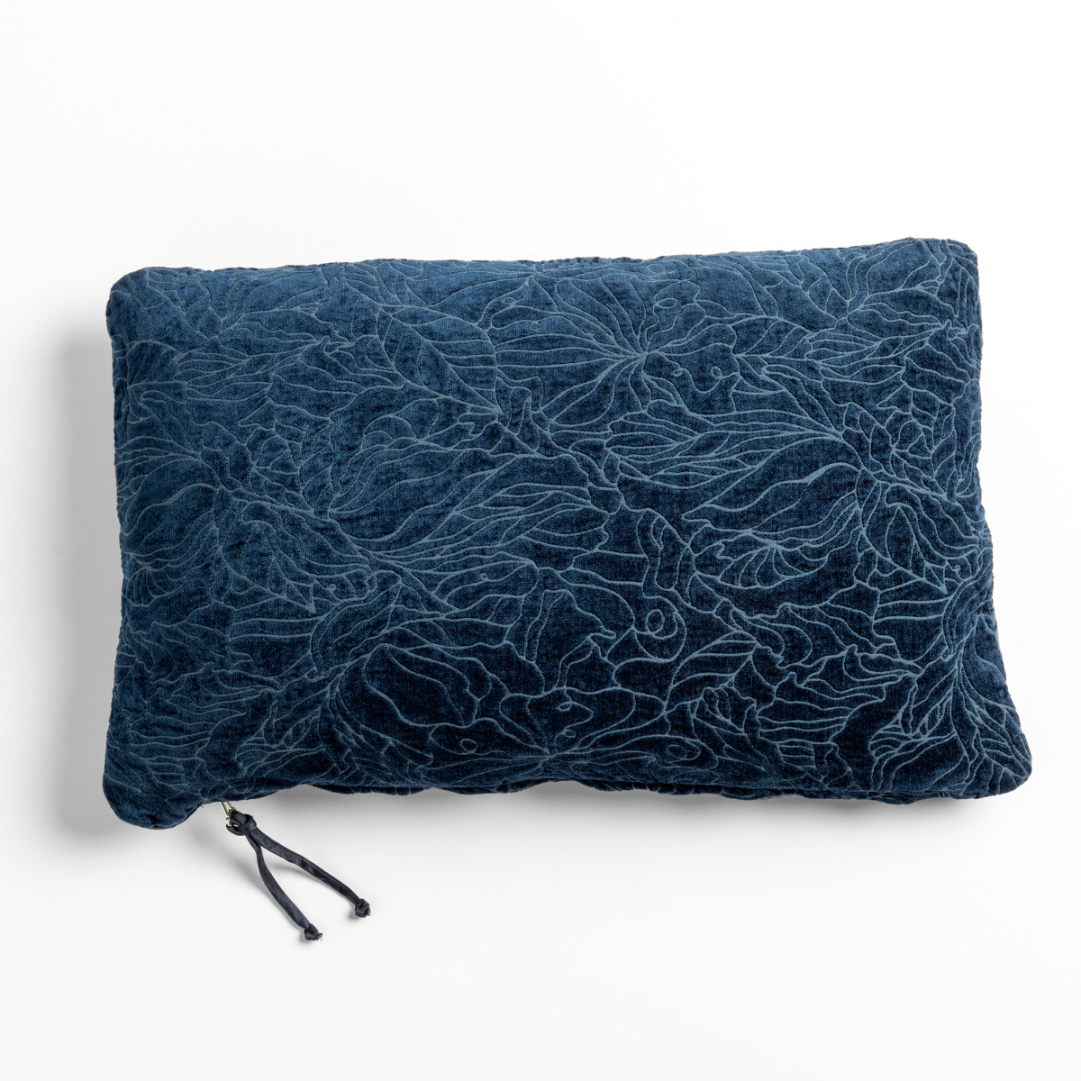 Midnight: chenille jacquard side of a rectangle throw pillow shown from overhead against a white background.