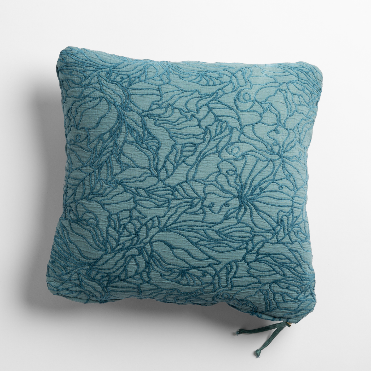 Cenote: cotton jacquard side of a georgia square cushion shown from overhead against a white background.