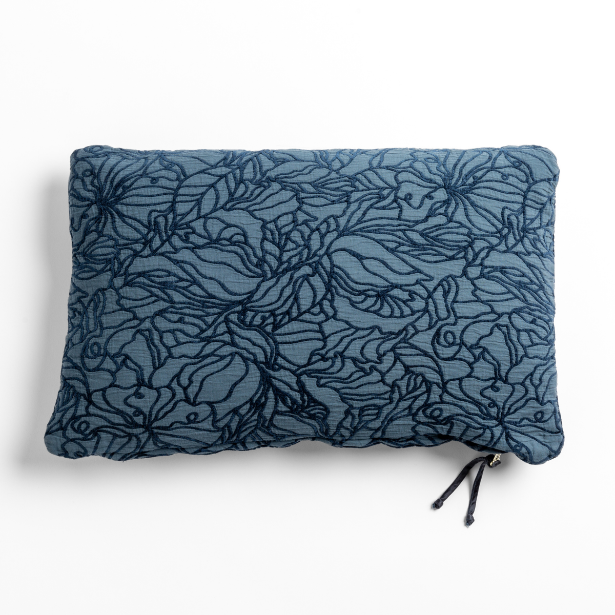 Midnight: cotton jacquard side of a rectangle throw pillow shown from overhead against a white background.