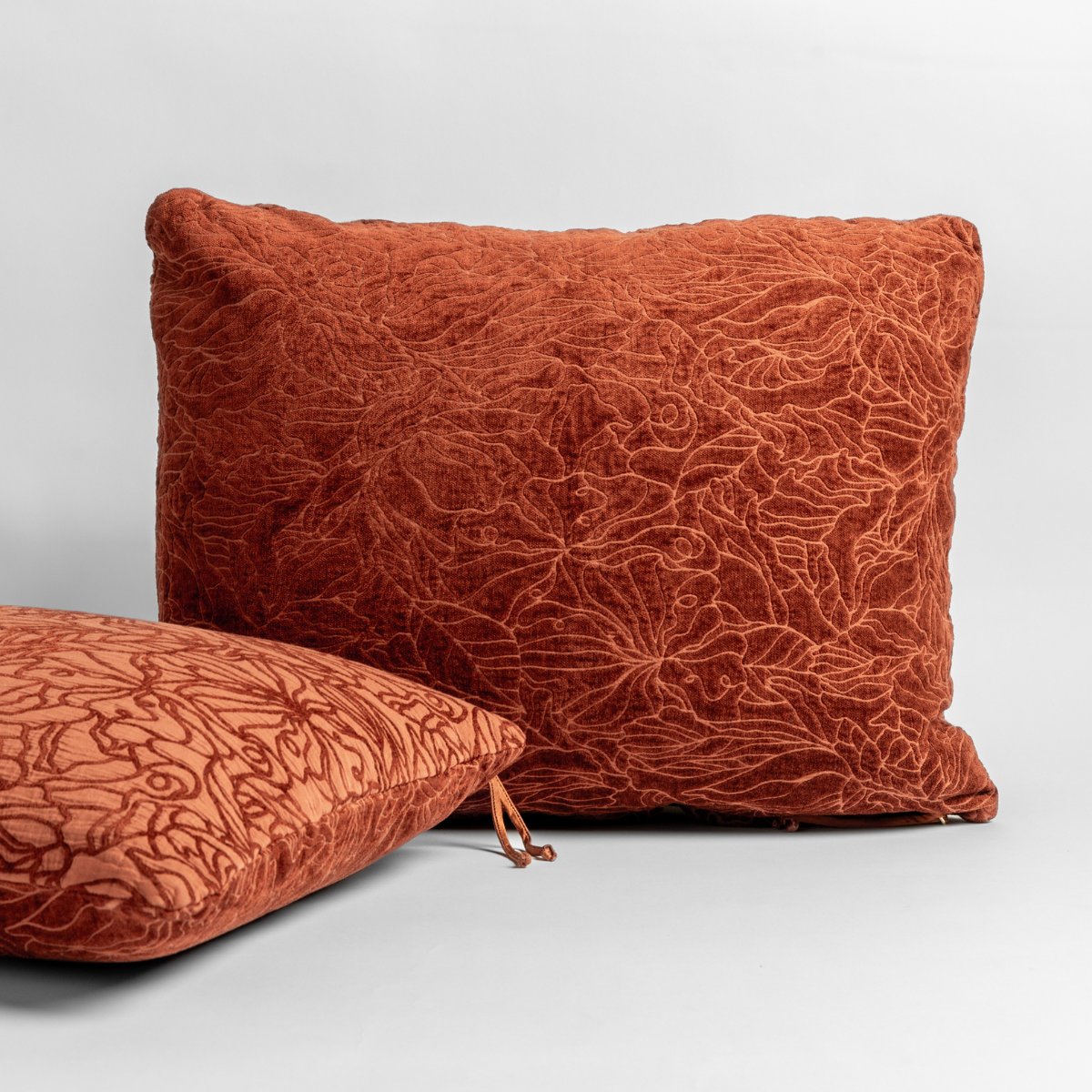 Autumn: A pair of Georgia Shams with the chenille jacquard sides shown in Autumn, a rich terracotta tone, shown against a white background.