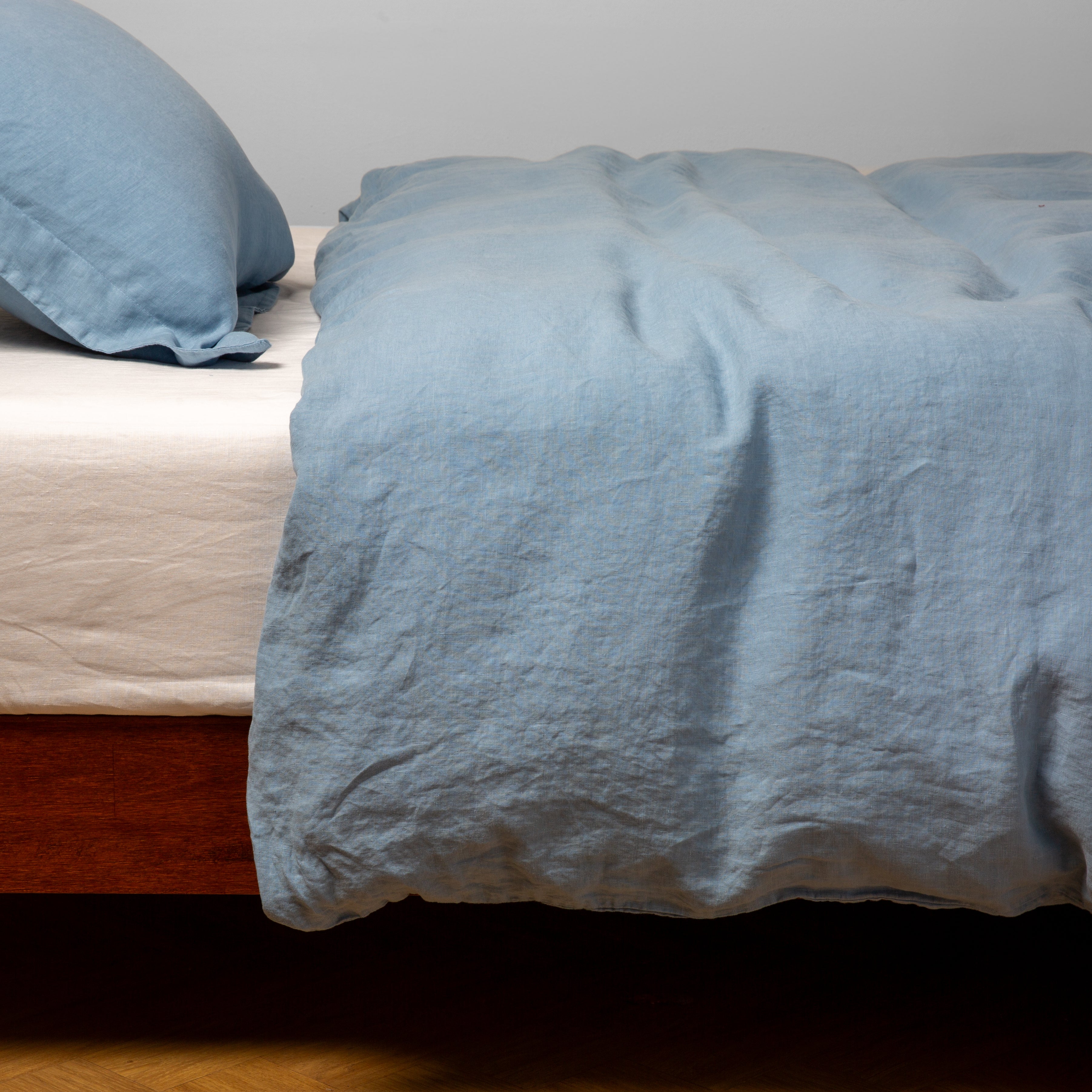 Tahoe Blue: duvet cover over white linen sheeting - side view.
