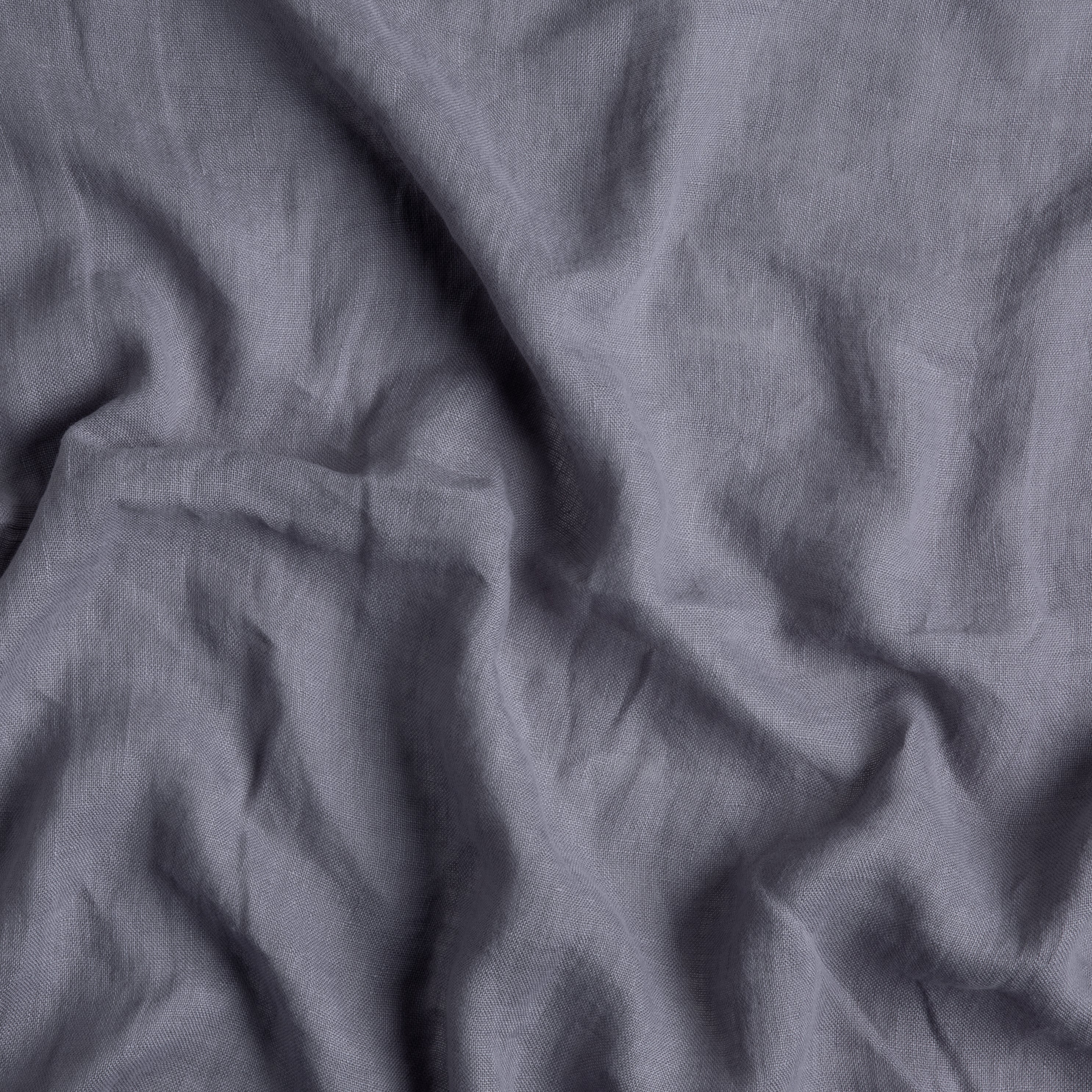 close up of rumpled linen whisper fabric in french lavender, a neutral purple tone.