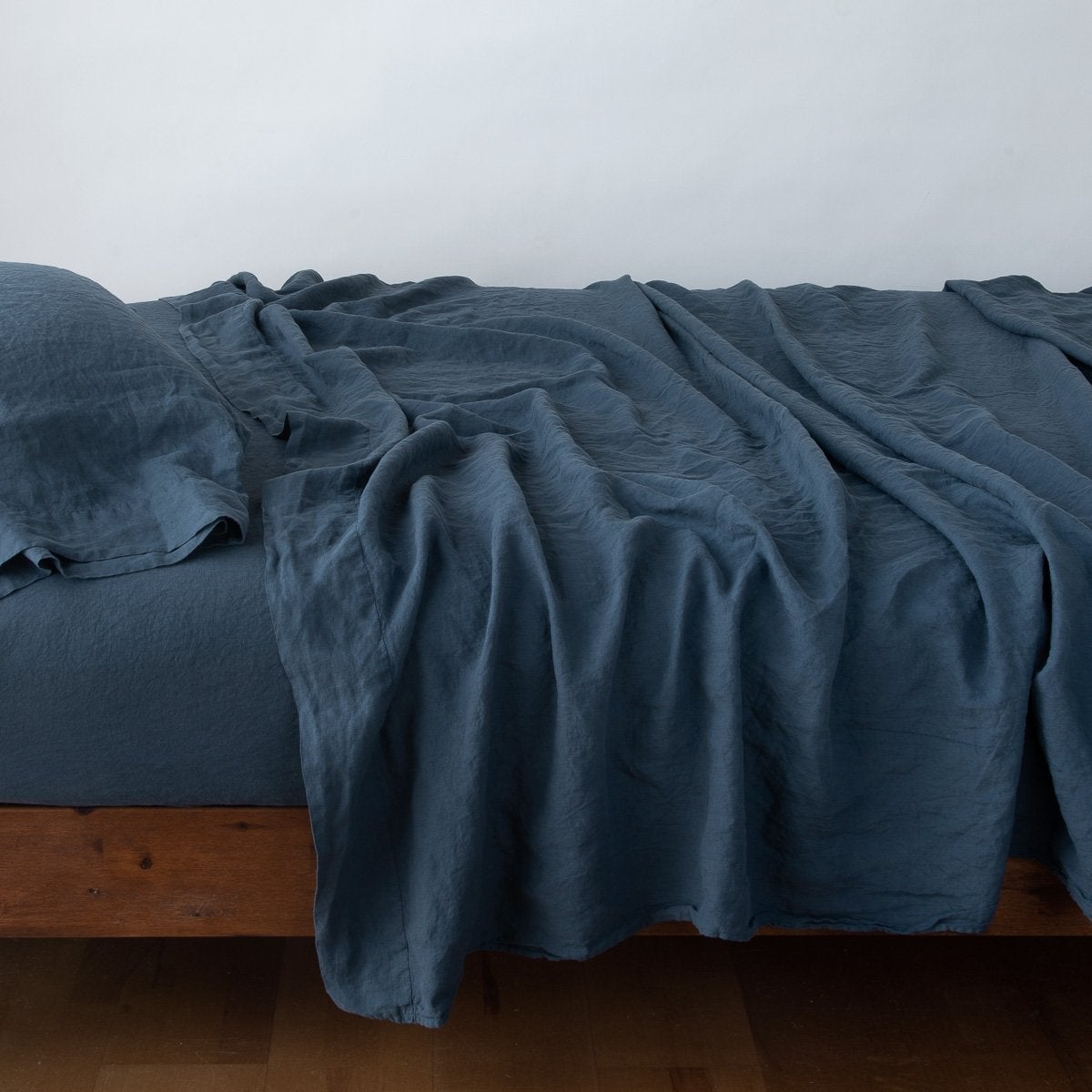 Midnight: sleeping pillow with matching rumpled sheeting - side view.