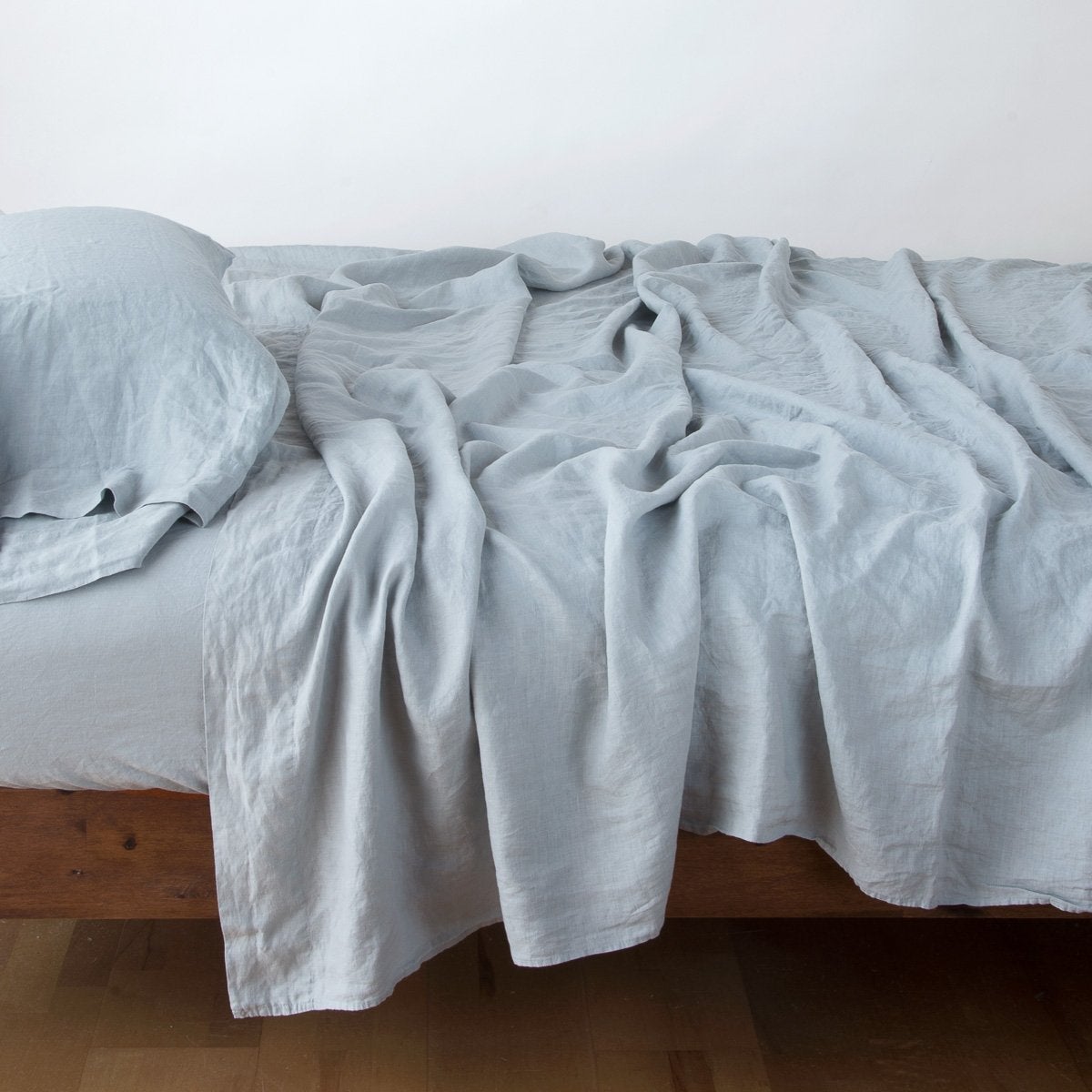 Mineral: sleeping pillow with matching rumpled sheeting - side view.