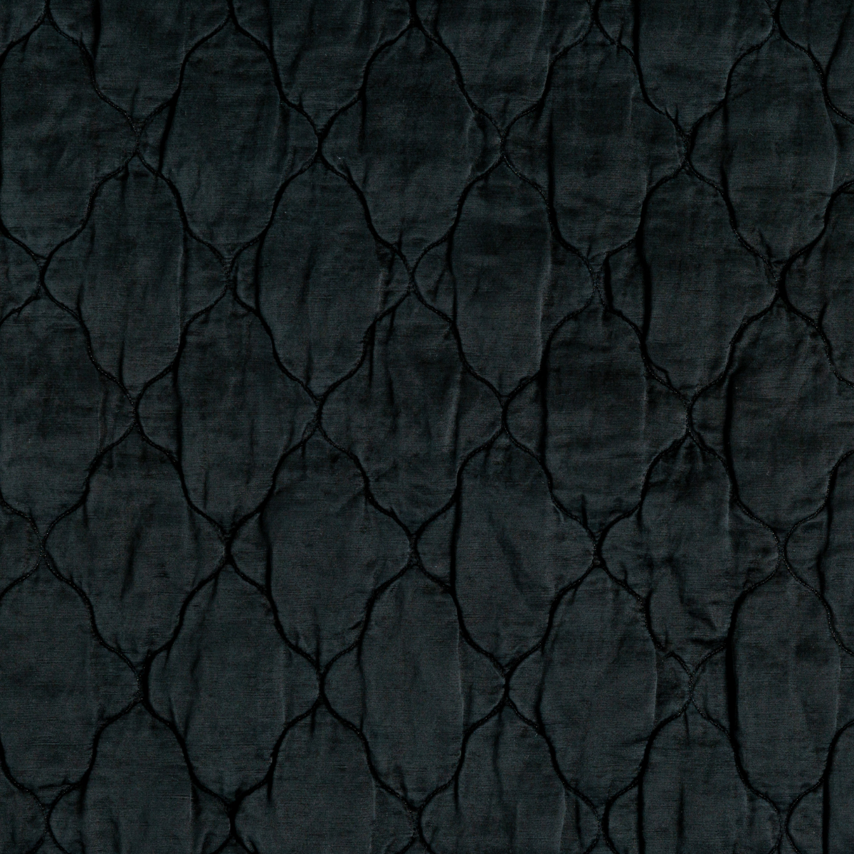 Corvino: A close up of quilted charmeuse fabric in Corvino, a black tone.