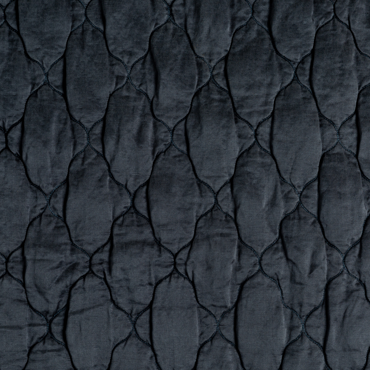 Midnight: A close up of quilted charmeuse fabric in midnight, a rich indigo tone.