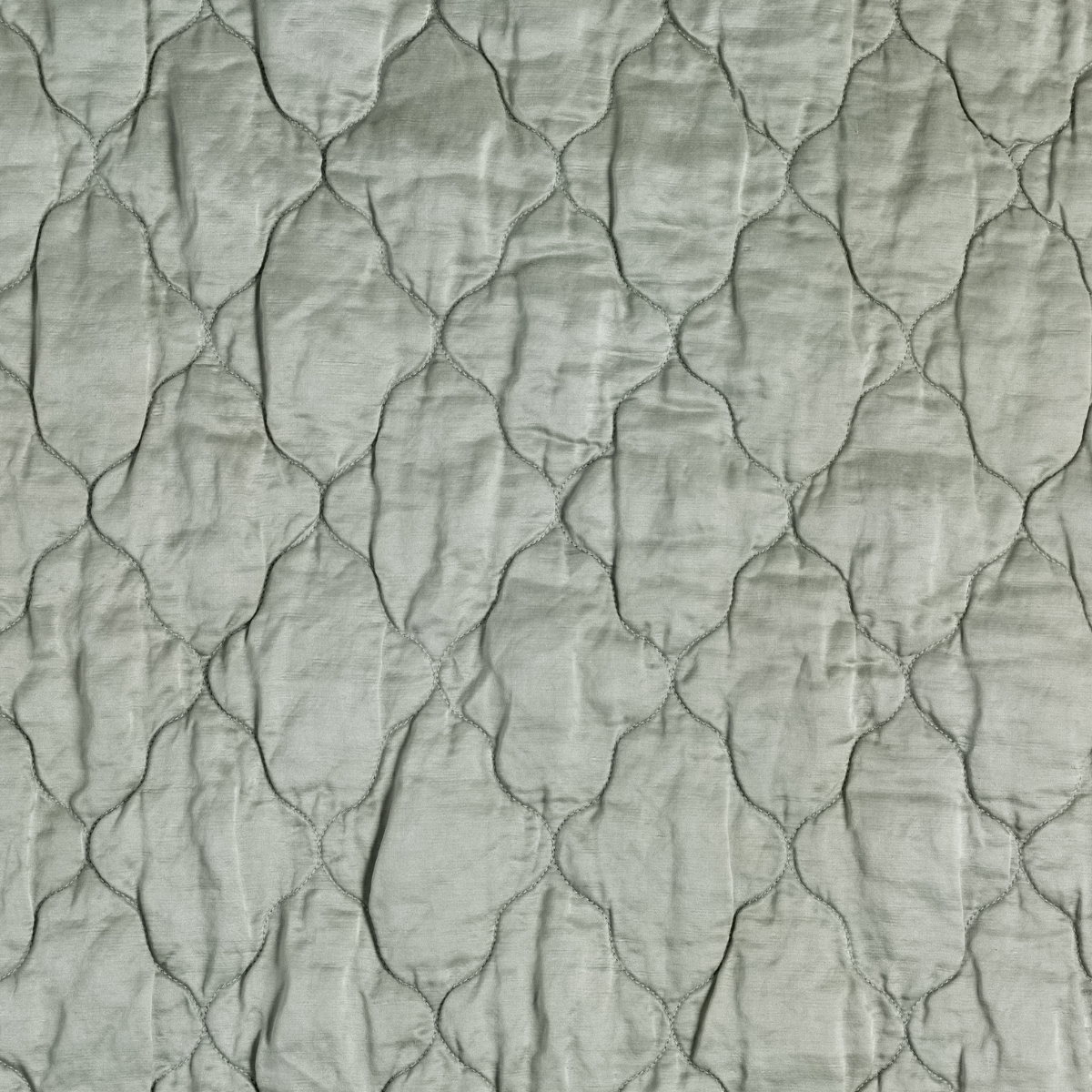 Mineral: A close up of quilted charmeuse fabric in mineral, a soothing seafoam blue with subtle grey-green undertones.