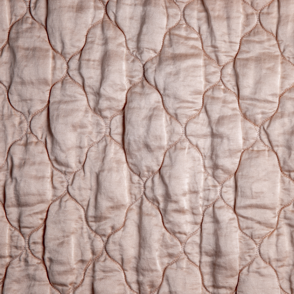 Rouge: A close up of quilted charmeuse fabric in rouge, a mid-tone blush pink.