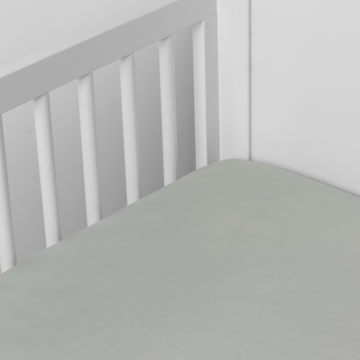 Eucalyptus: crib sheet shown on a mattress shown from overhead into the corner of a crib.
