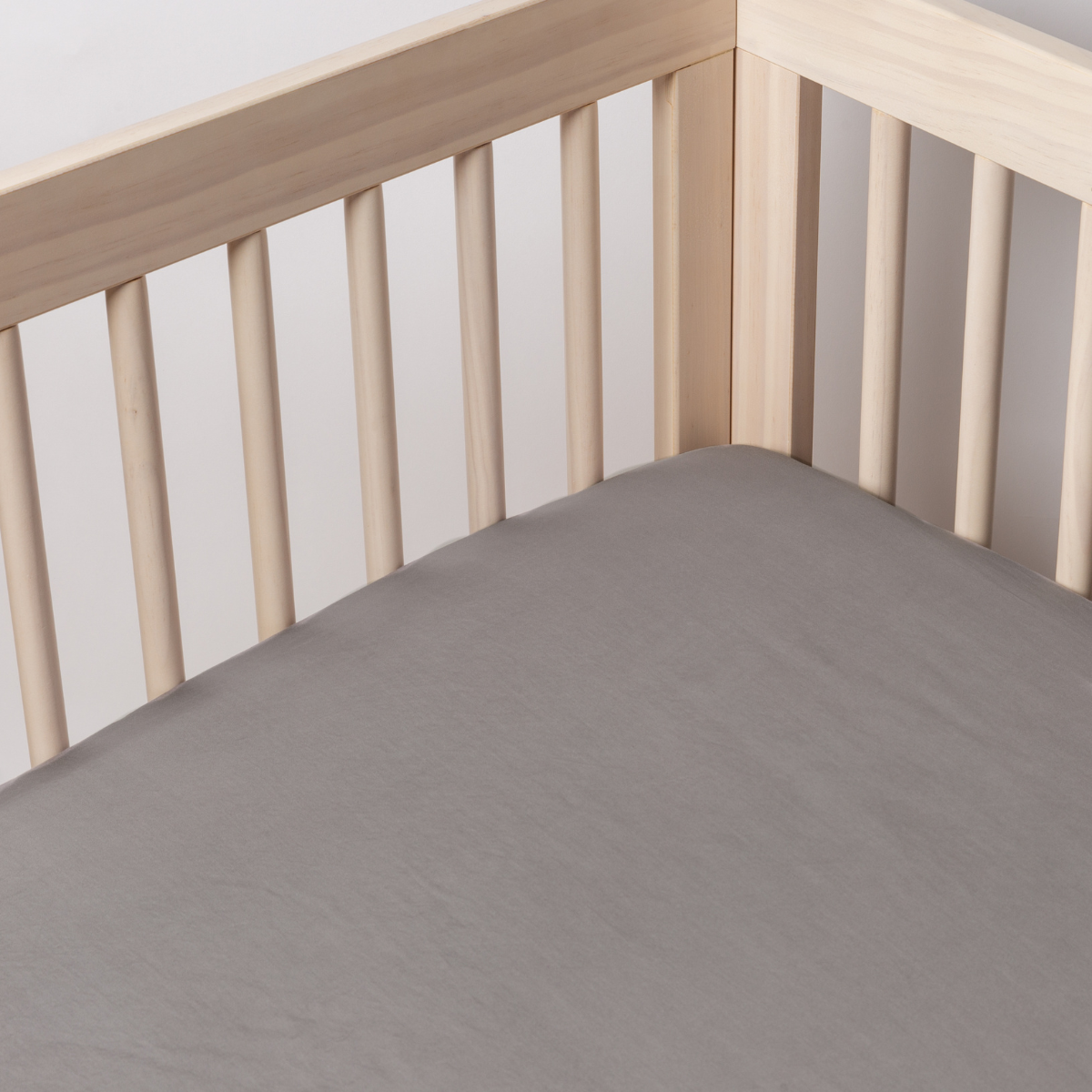 French Lavender: a shot of a tencel crib sheet shot into the inside corner of a crib.