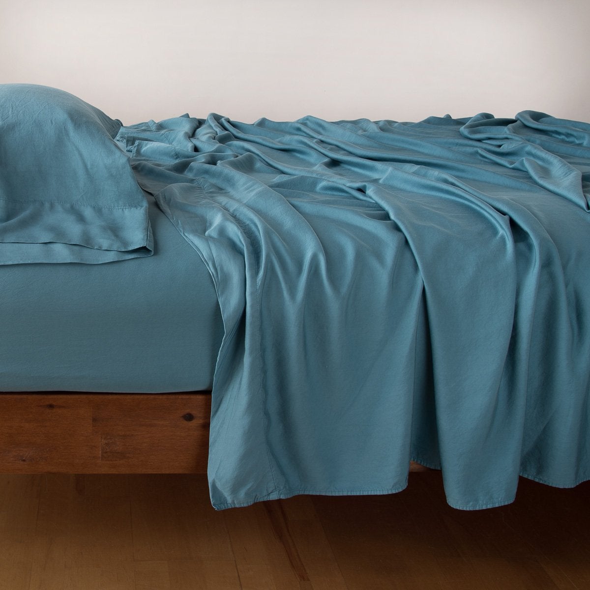 Cenote: sleeping pillow with matching rumpled sheeting - side view.