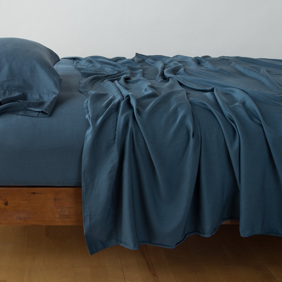 Midnight: sleeping pillow with matching rumpled sheeting - side view.