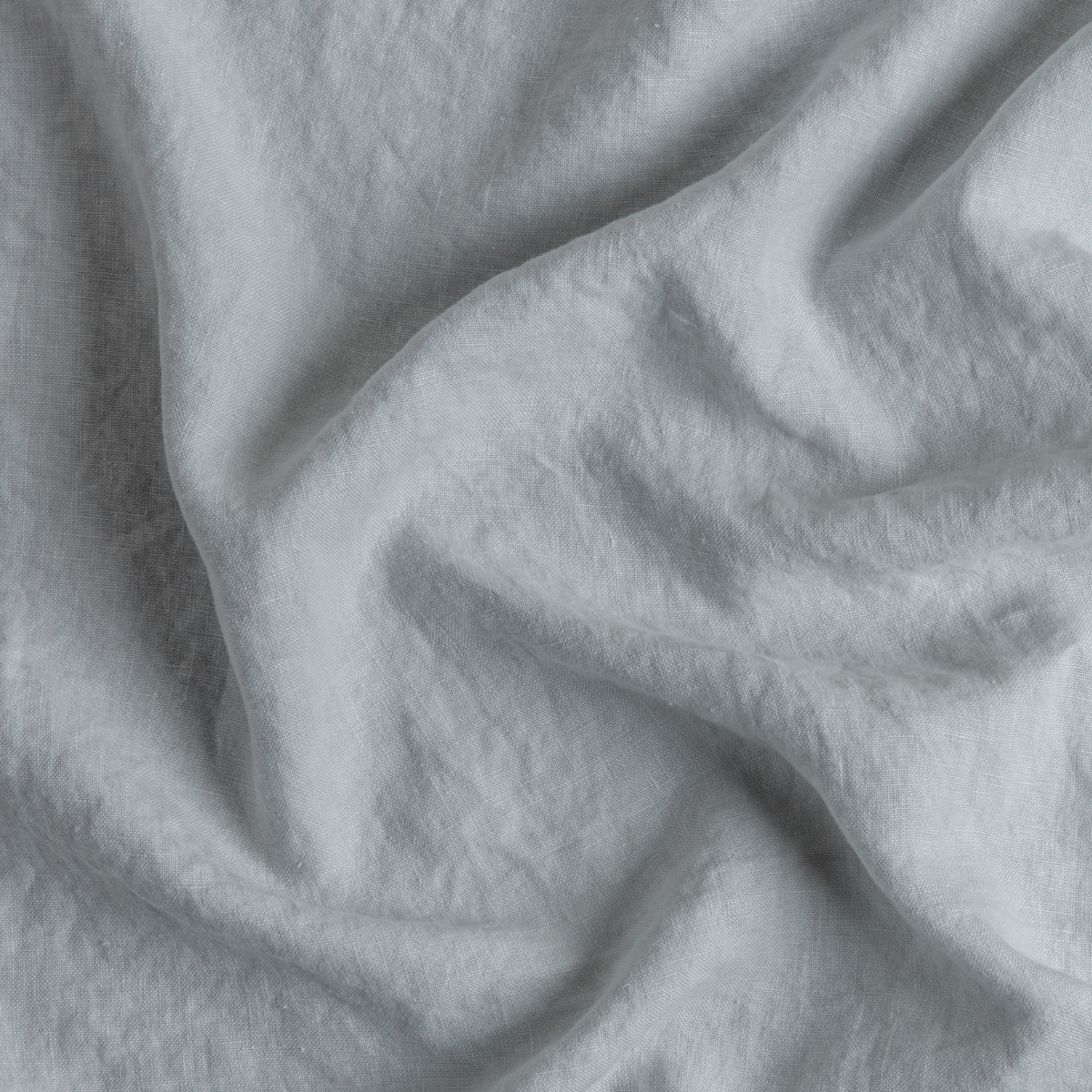 Mineral: A close up of midweight linen fabric in mineral, a soothing seafoam blue with subtle grey-green undertones.