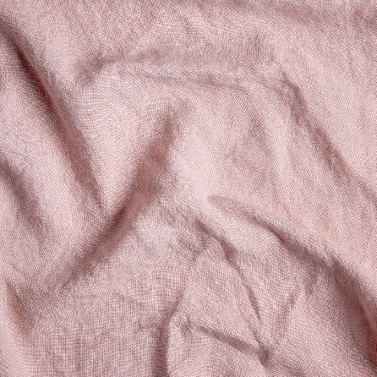 Rouge: A close up of midweight linen fabric in rouge, a mid-tone blush pink.