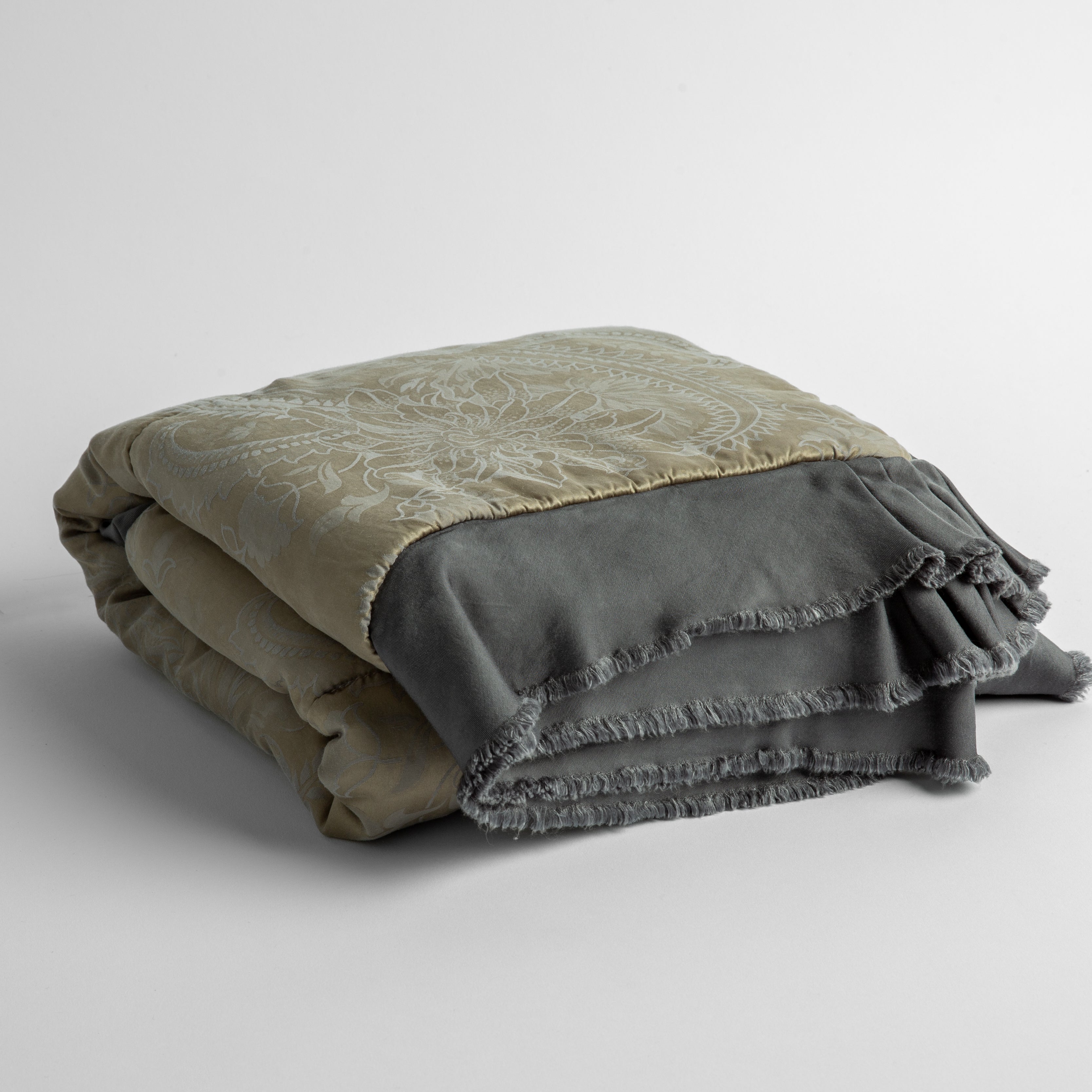 Moonlight: silk and tencel™ blend jacquard baby blanket folded and shot from a slight overhead angle to show the trim detail against a white background.