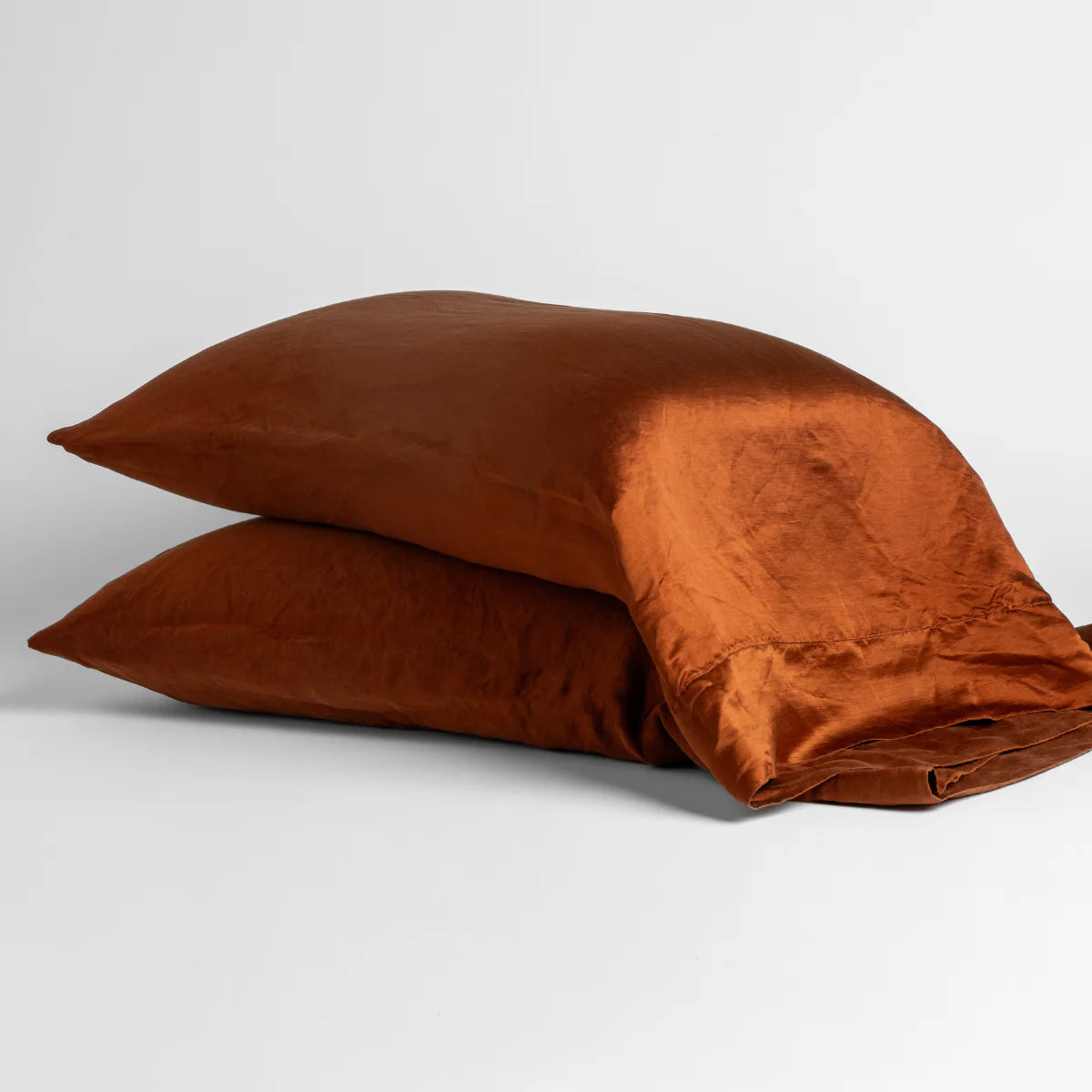 Autumn: two sleeping pillows neatly stacked on white background.